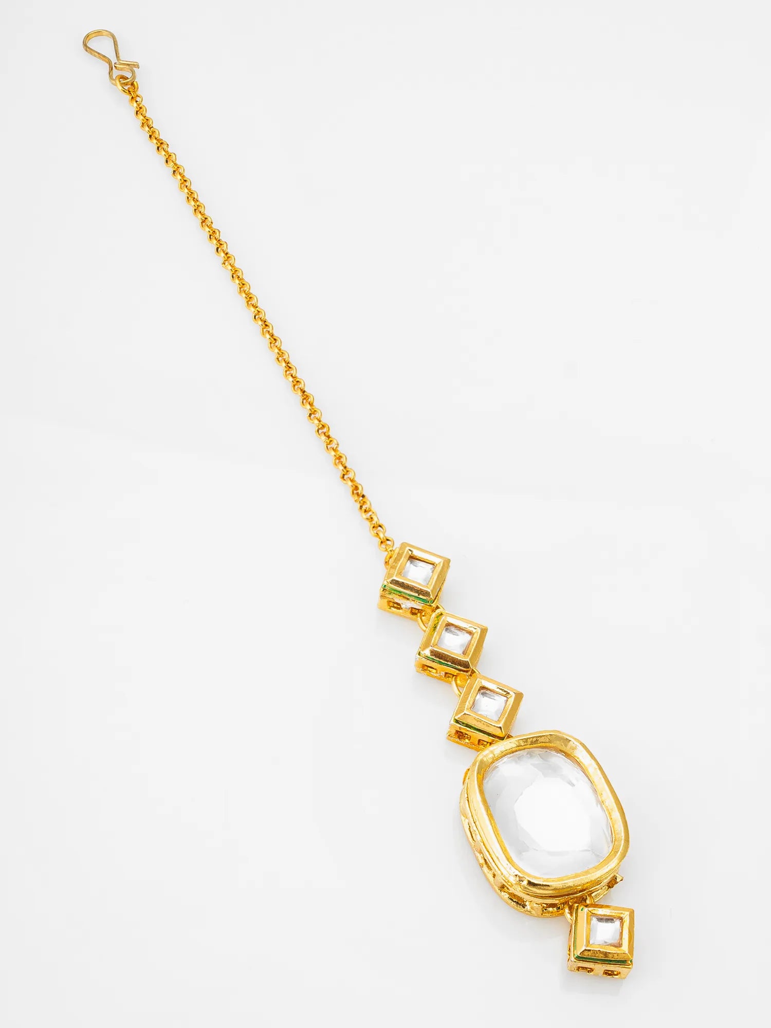 Gold necklace with geometric pendant on a white background
