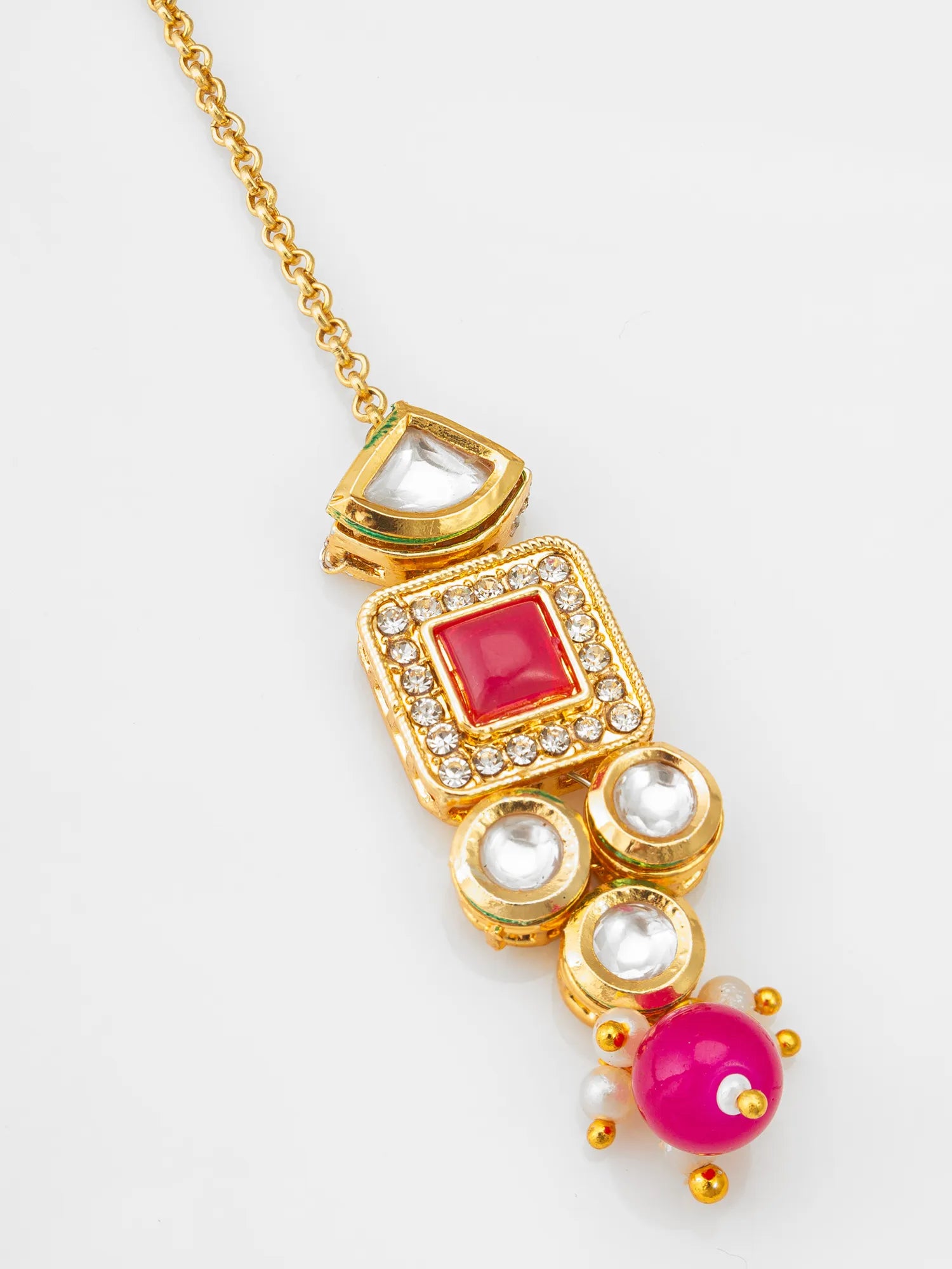 Gold necklace with pink and white gemstones on a light gray background