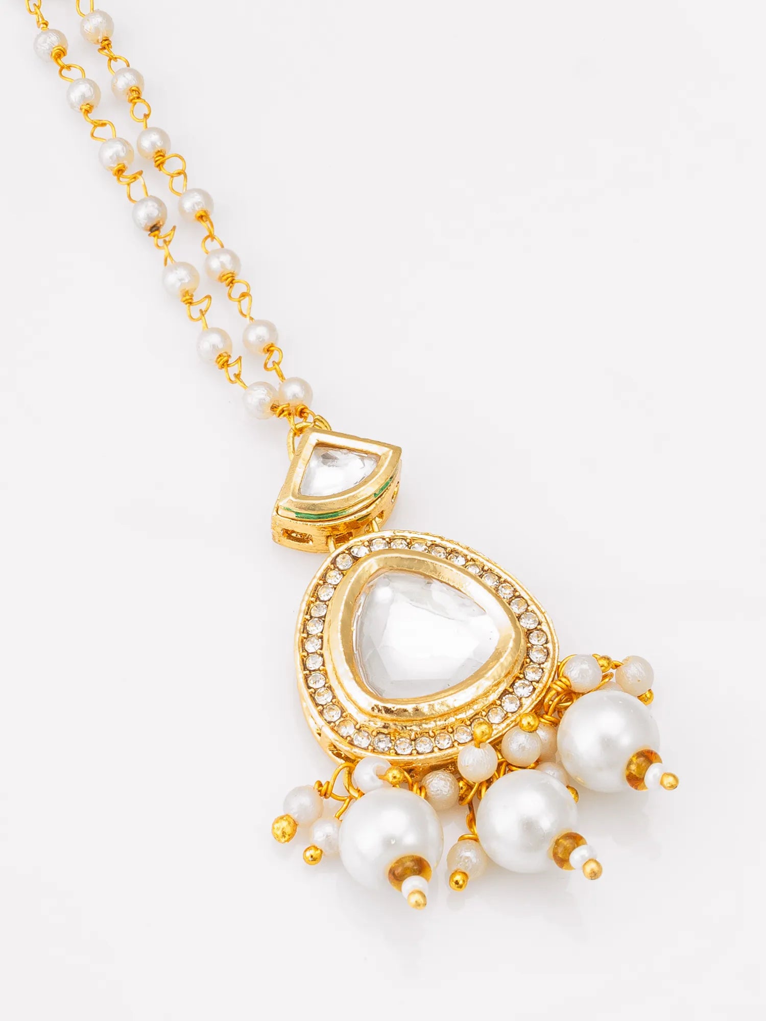 Gold necklace with pearl pendants on a white background