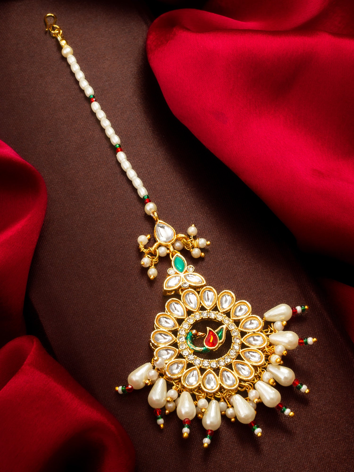 Aadita Gold Plated Kundan Peacock Maang Tikka with Pearl and Red-Green Bead Chain