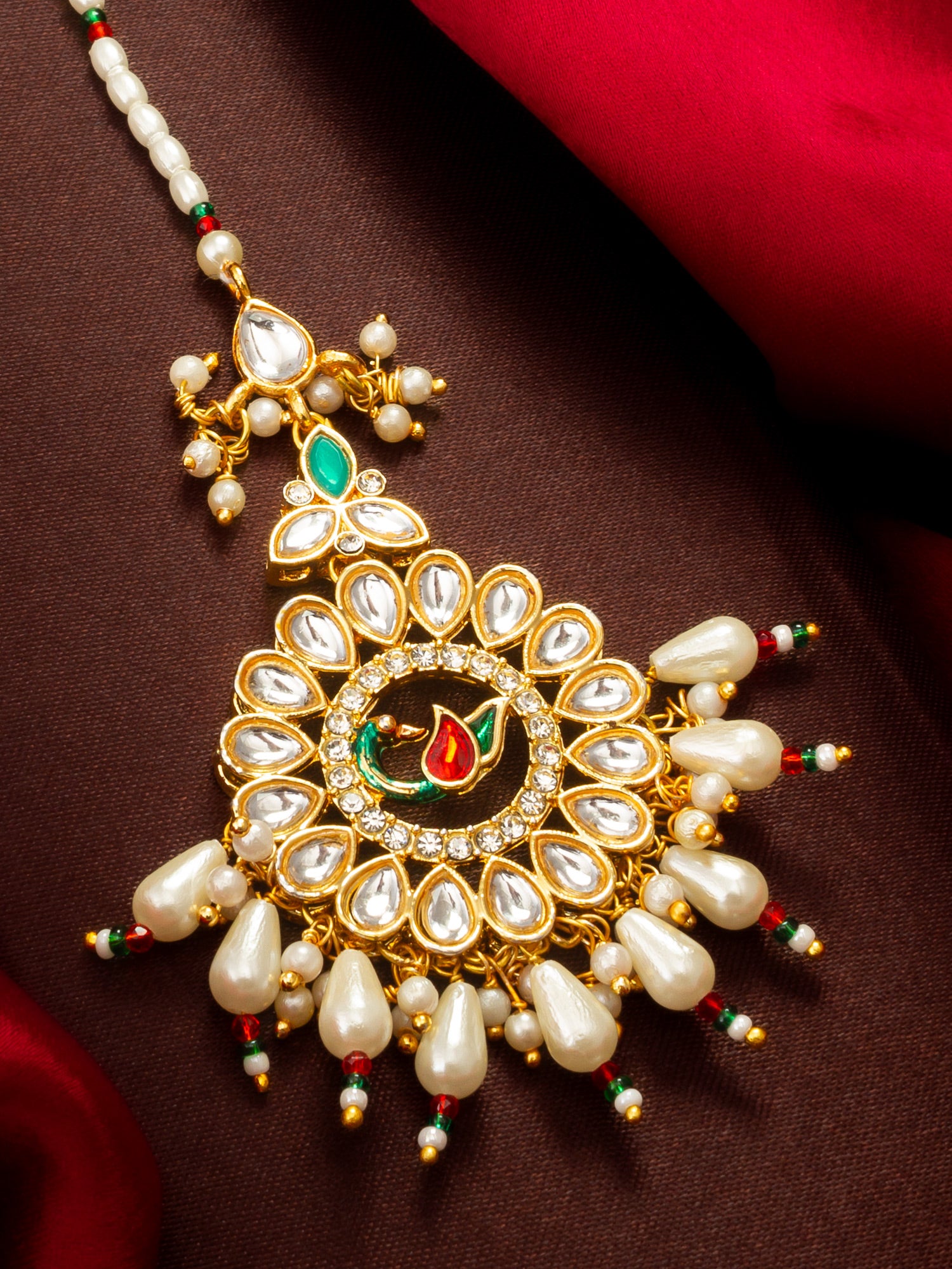 Aadita Gold Plated Kundan Peacock Maang Tikka with Pearl and Red-Green Bead Chain