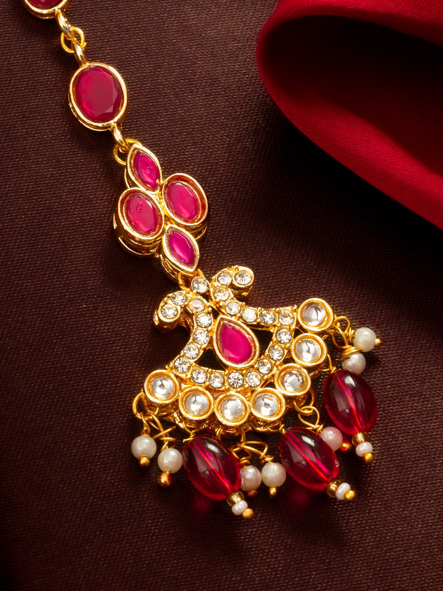 Aadita Gold Plated Ruby Oval Chain Mangtika with Cross Kundan Pendant and Pink Bead Drops