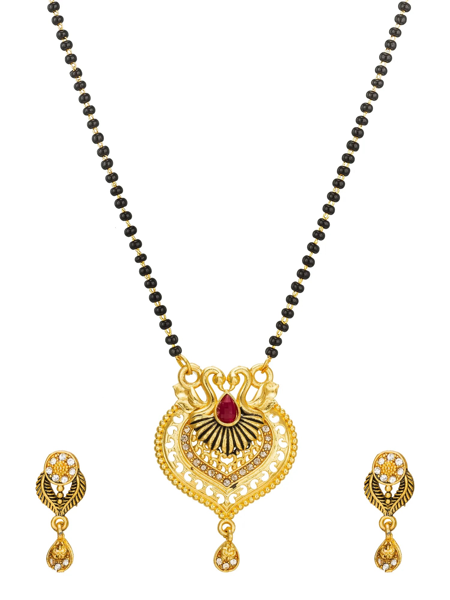 Gold-toned jewelry set featuring a necklace with a heart-shaped pendant, a red teardrop gemstone, and a black beaded chain, shown with matching drop earrings on a white background.
