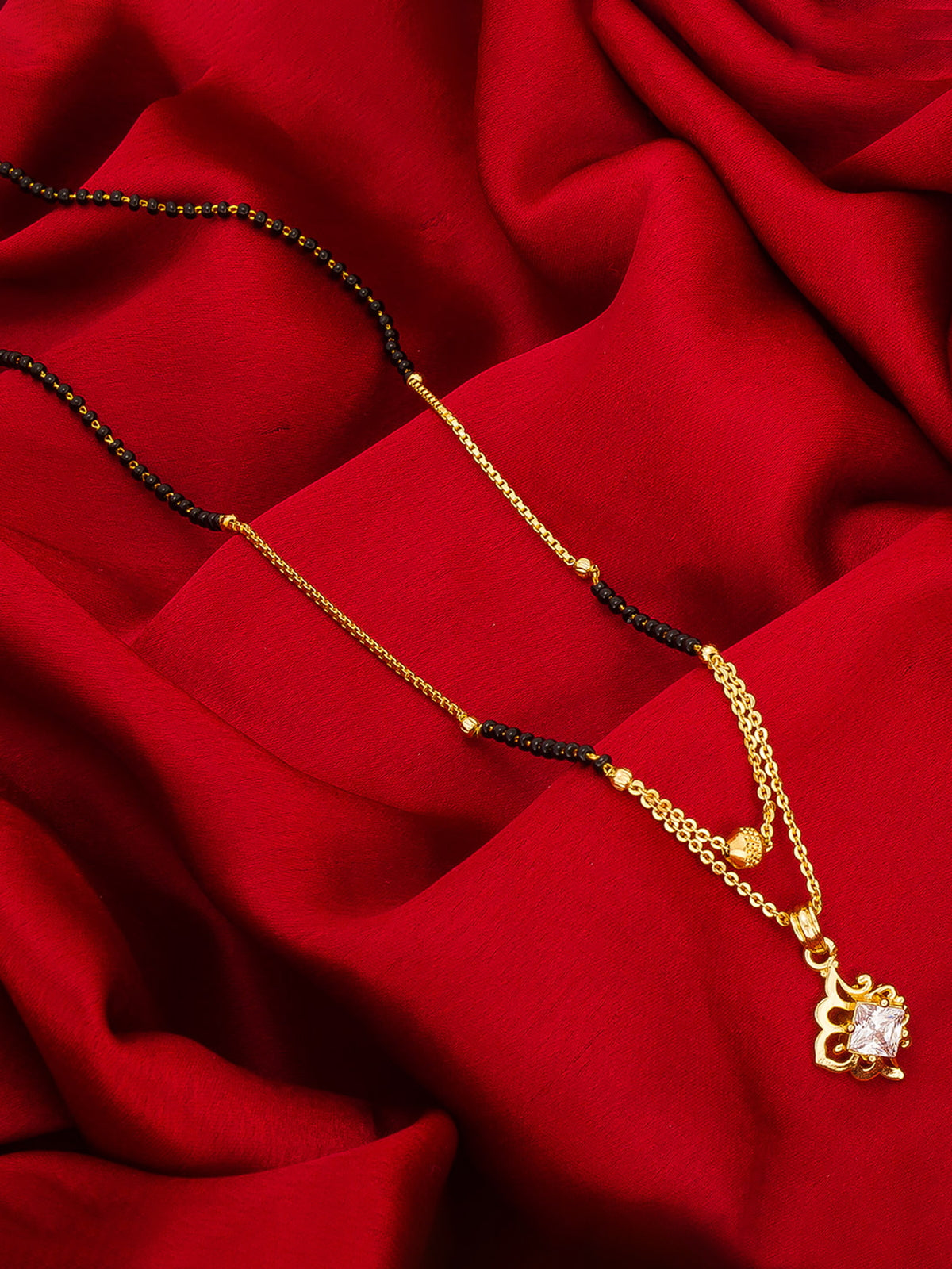 Aadita Gold-Toned Square Solitaire Mangalsutra with Filigree Scroll Pendant and Black Beads Dual Chain For Festive Wear
