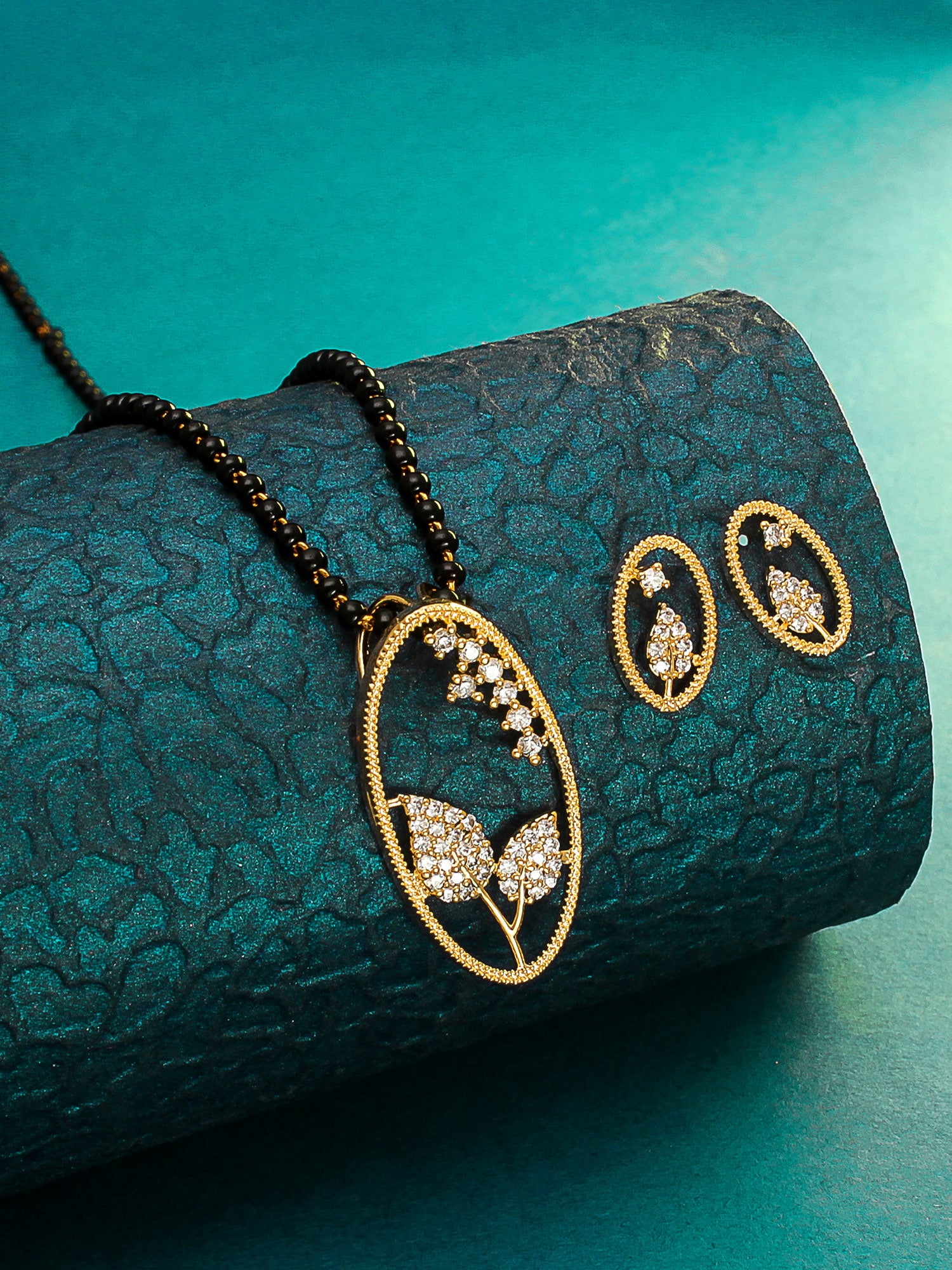 Aadita Office Wear Gold-Toned Oval Floral Mangalsutra Set with Long Black Beads Chain and Matching Earrings