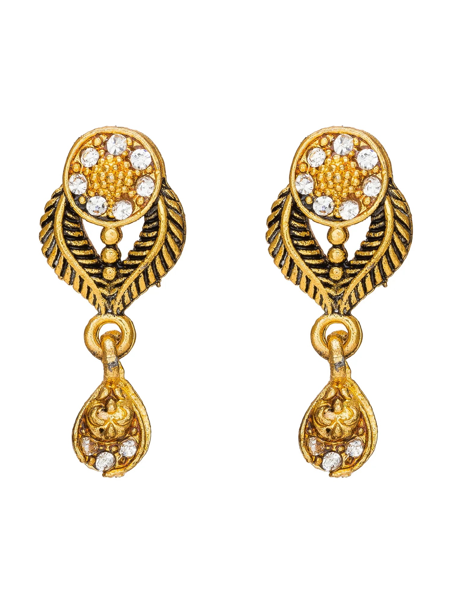 A pair of gold-toned traditional Indian earrings with leaf-shaped designs, textured patterns, and small clear stones, shown on a plain white background.
