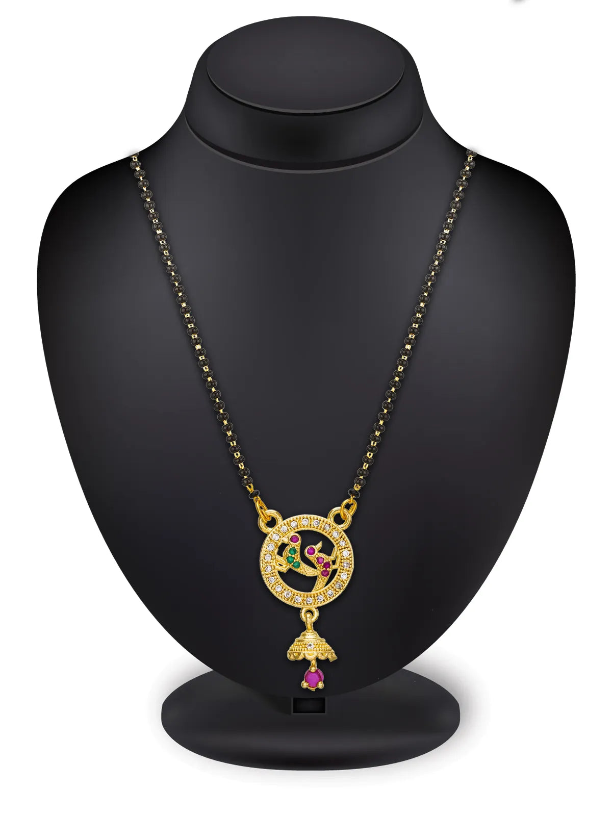 Gold-tone necklace with a circular pendant featuring a peacock motif and a dangling bell-shaped charm with a pink stone, displayed on a black jewelry bust against a white background.