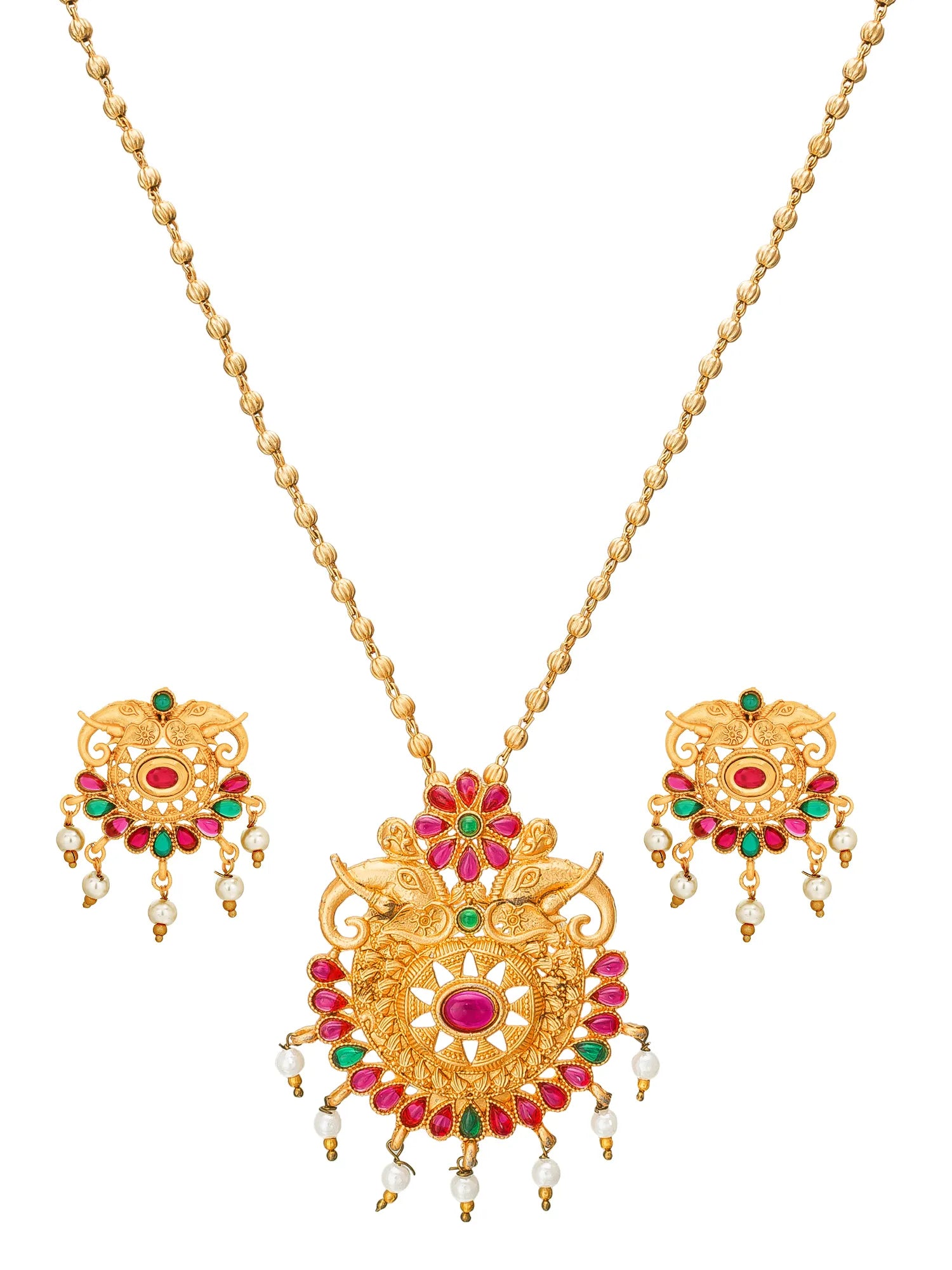 Gold-toned traditional jewelry set featuring a necklace with a large ornate pendant, matching drop earrings, and small pearl-like beads, decorated with red and green stones on a plain white background.