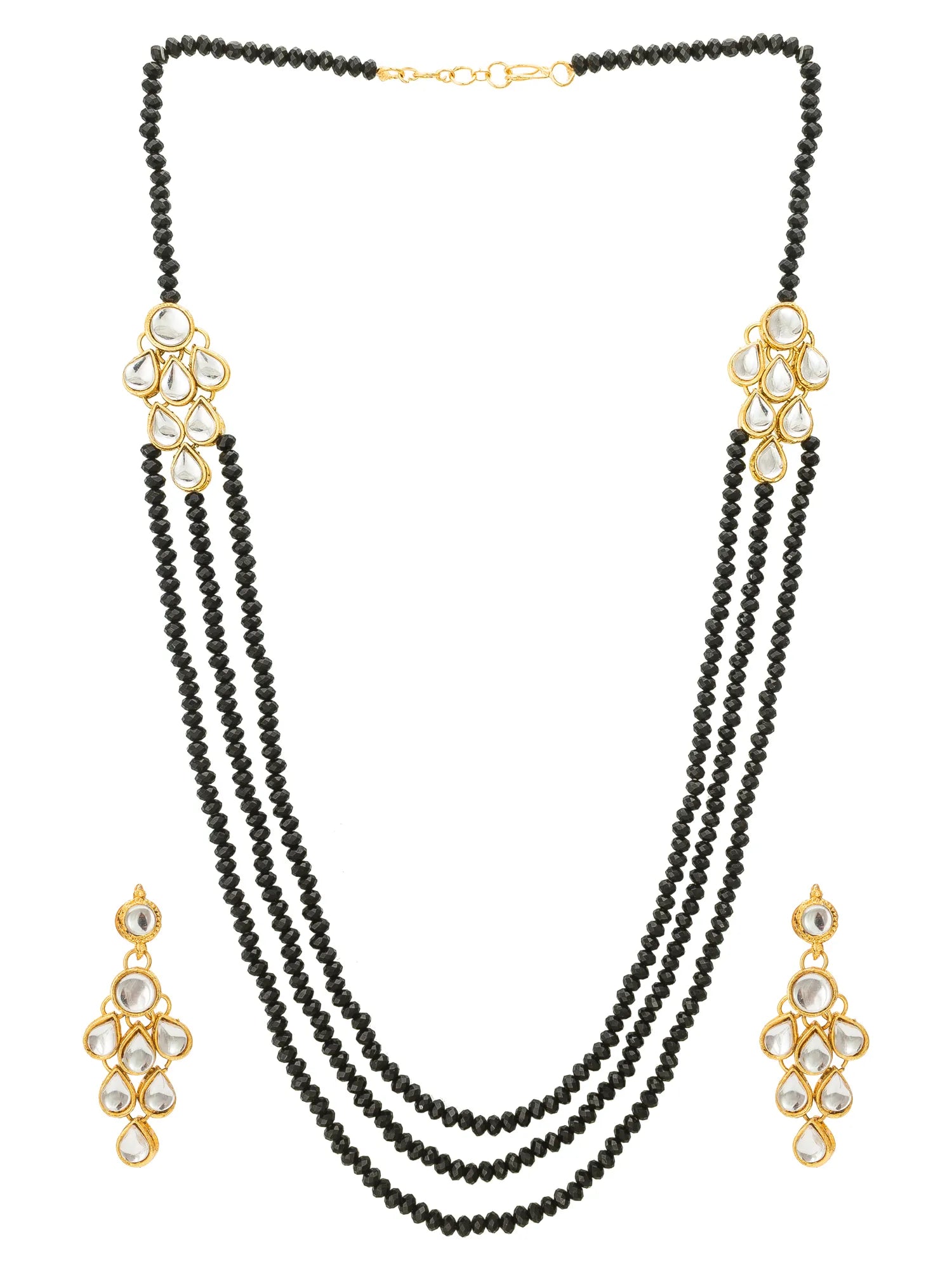 A three-strand black beaded necklace with gold-plated floral accents and clear stones, shown with matching drop earrings on a plain white background.