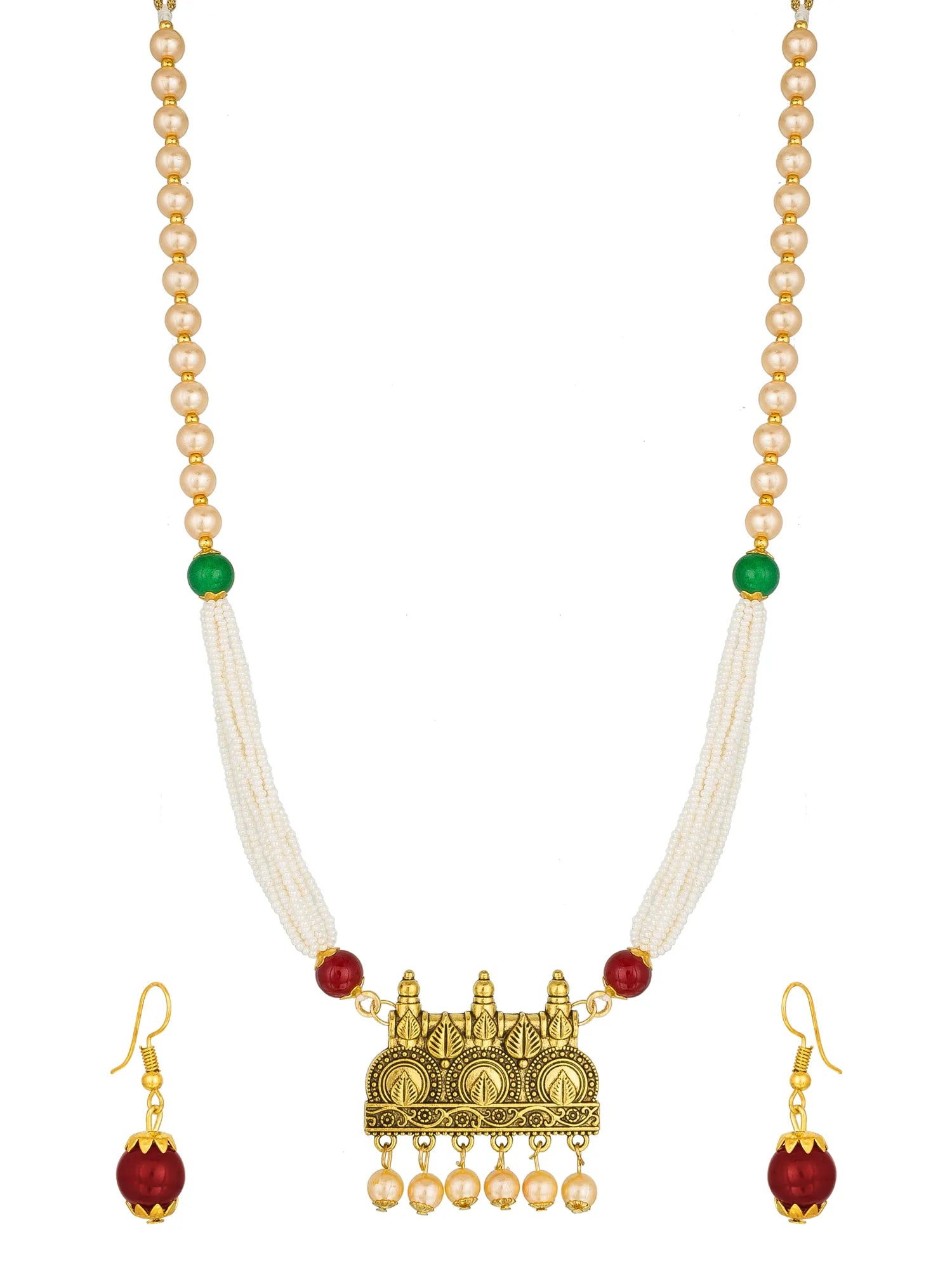 A traditional Indian jewelry set featuring a gold-plated pendant necklace with white pearl strands, red and green beads, and matching gold earrings, displayed on a draped white satin fabric background.