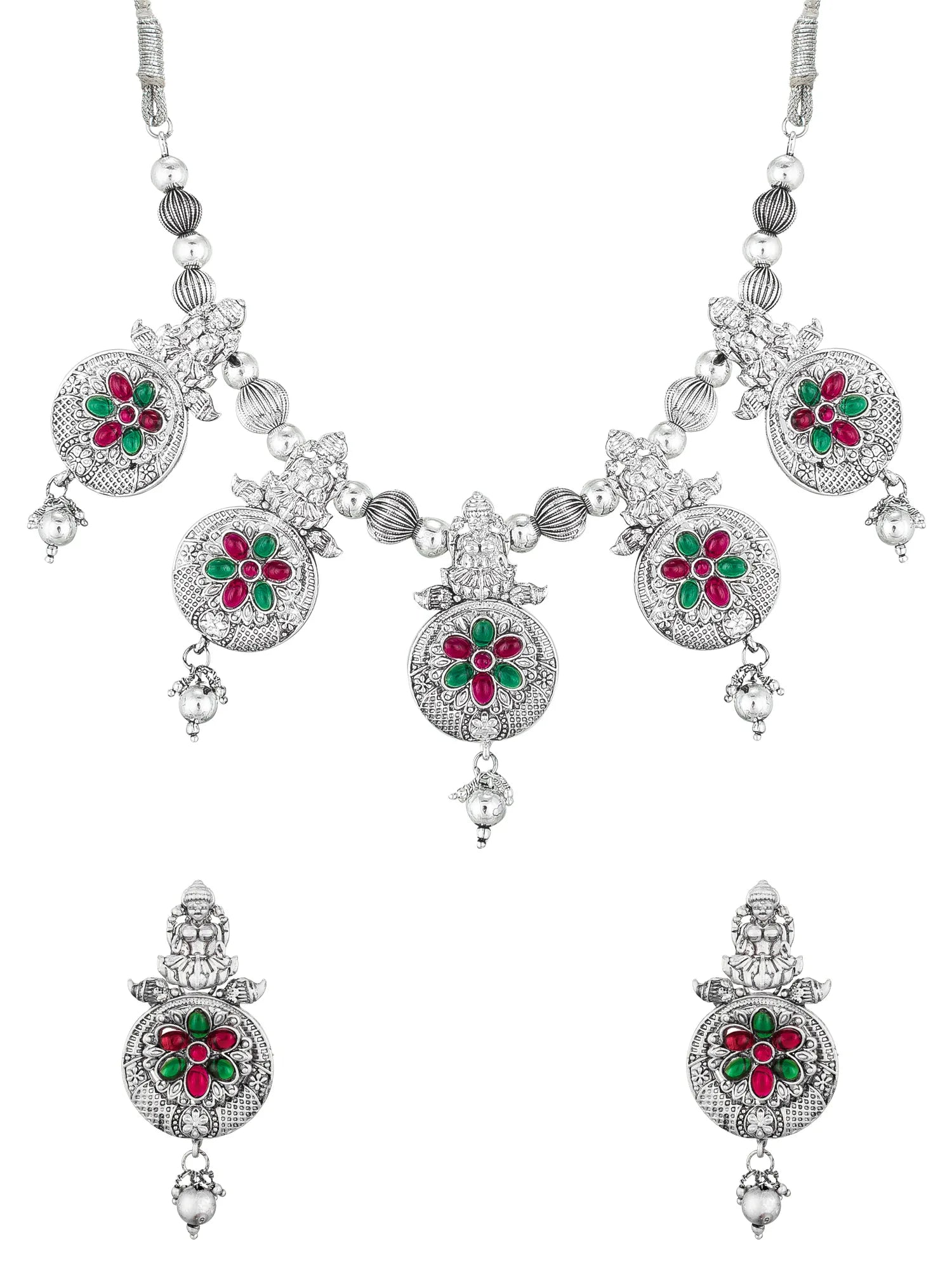 A silver-toned traditional Indian jewelry set featuring a necklace and matching earrings, decorated with red and green enamel floral motifs and clear stones.