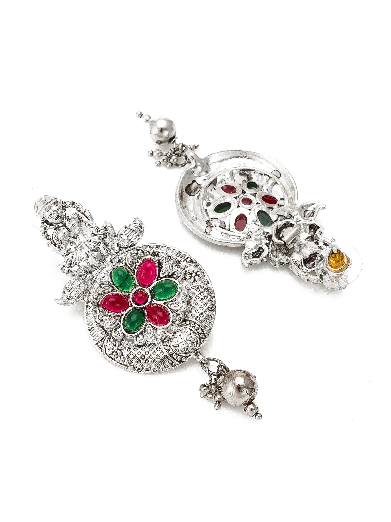A pair of silver-toned Indian Kundan dangle earrings decorated with red and green stones, shown on a plain white background.