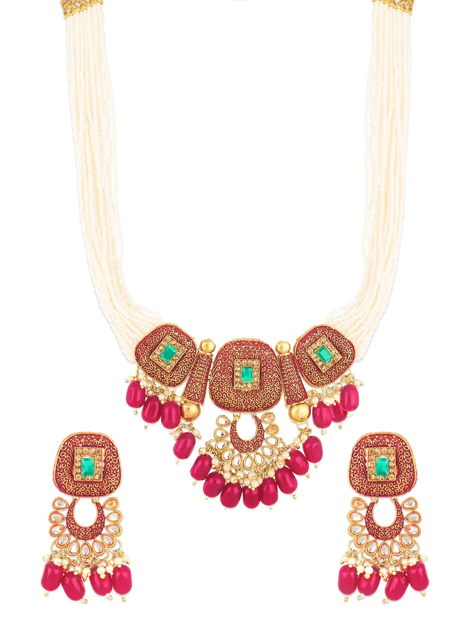 A traditional Indian jewelry set featuring a statement necklace and matching earrings. The necklace has a cream-colored multi-strand cord, a gold-plated ornate collar with red stone inlay, green stone accents, and dangling red beads.