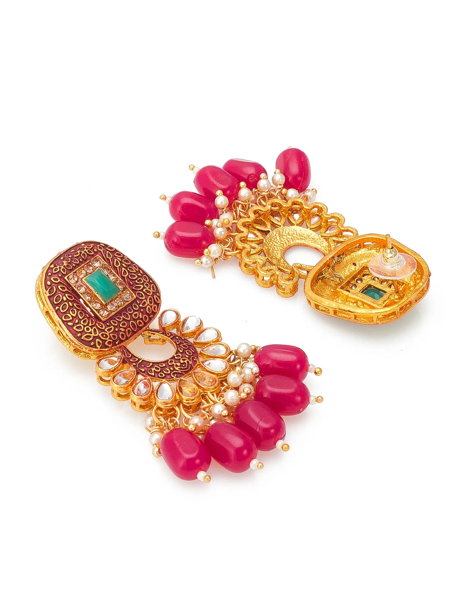 A pair of ornate gold-toned traditional Indian earrings decorated with bright pink beads, white faux pearls, and green stone accents, displayed on a clean white background.