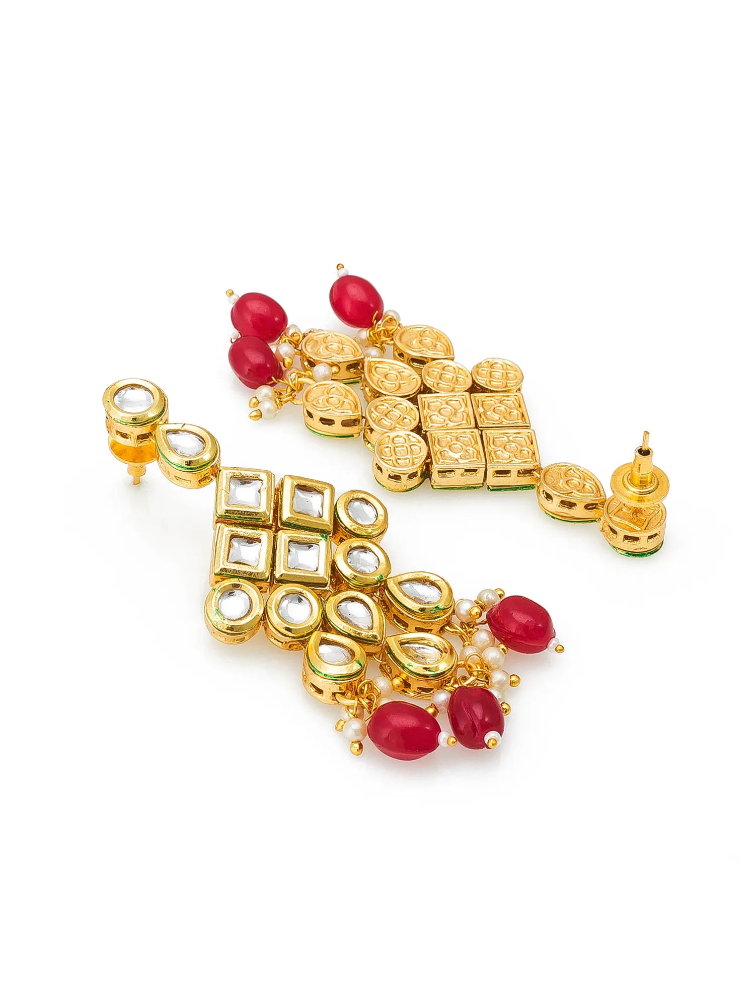A pair of ornate gold-toned Indian Kundan earrings decorated with red beads, white stones, and small pearl-like accents, displayed on a clean white background.