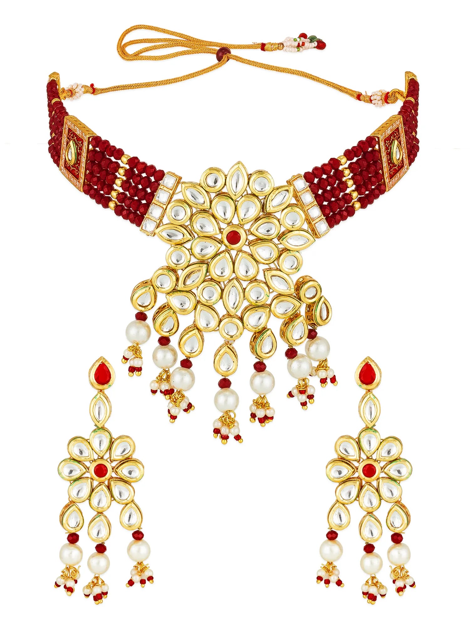 Gold and red beaded necklace set with a large floral pendant and matching drop earrings, decorated with white faux pearls and red gemstone accents, on a white background.
