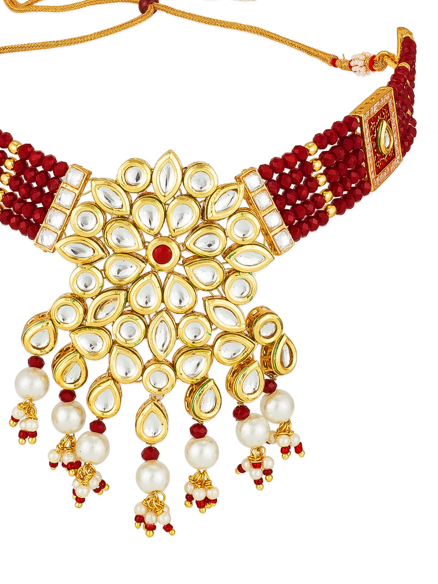 A traditional Indian gold-plated choker necklace with red bead strands, white kundan stone inlays, and dangling pearl beads with red and gold accents, shown on a plain white background.