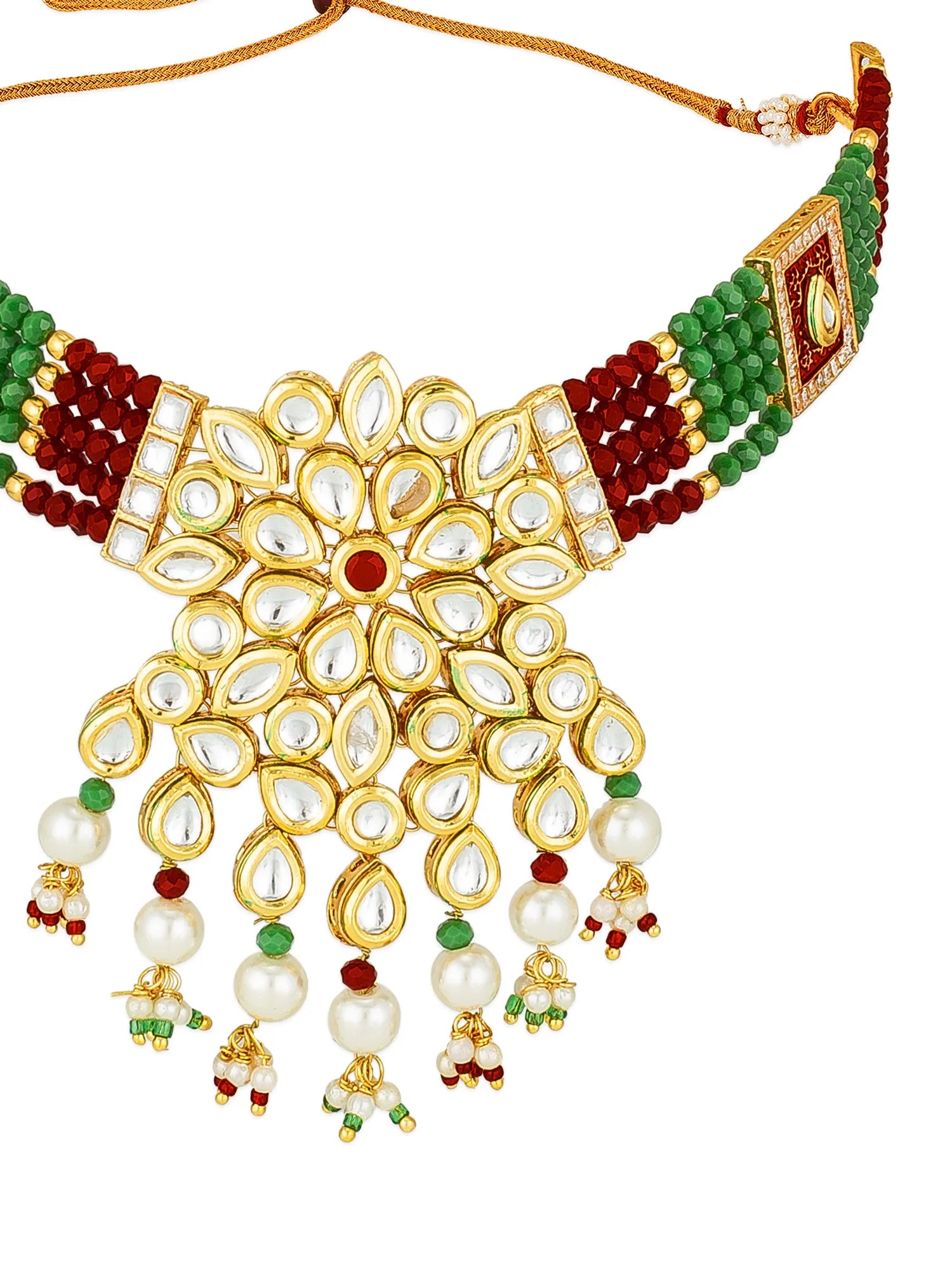 An ornate Indian Kani necklace featuring a large gold-plated floral pendant adorned with clear stones, white pearls, and dangling bead drops in green, red, and gold, with matching beaded shoulder straps on a white background.