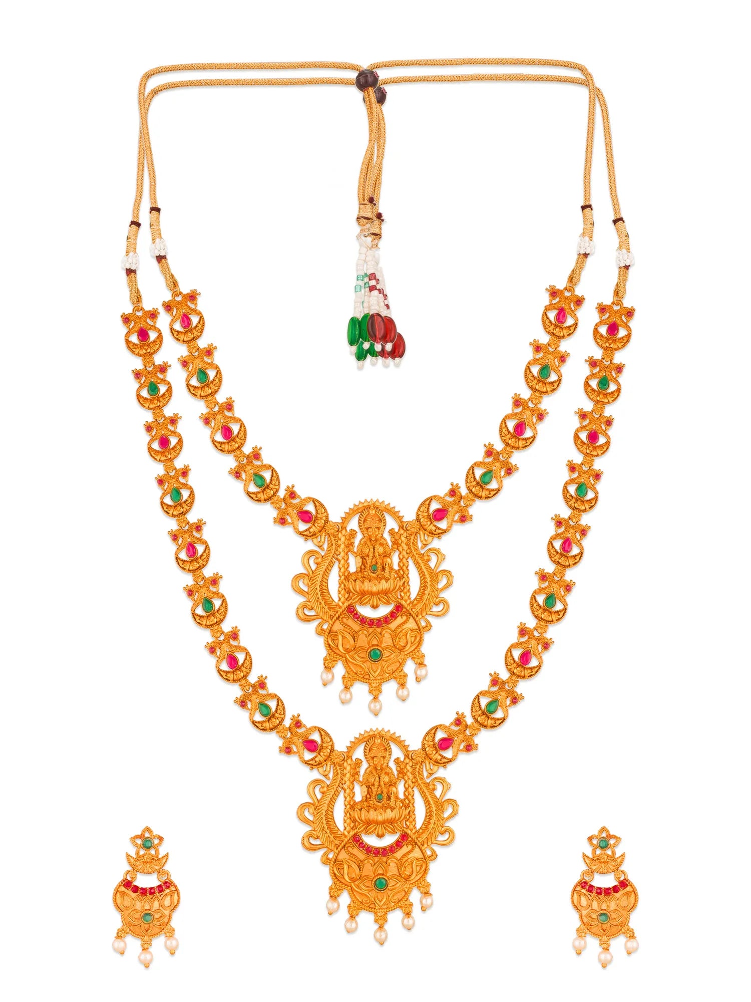 A traditional Indian gold-plated necklace set with a long double-strand necklace and matching earrings, decorated with red and green stones and white pearl-like accents.