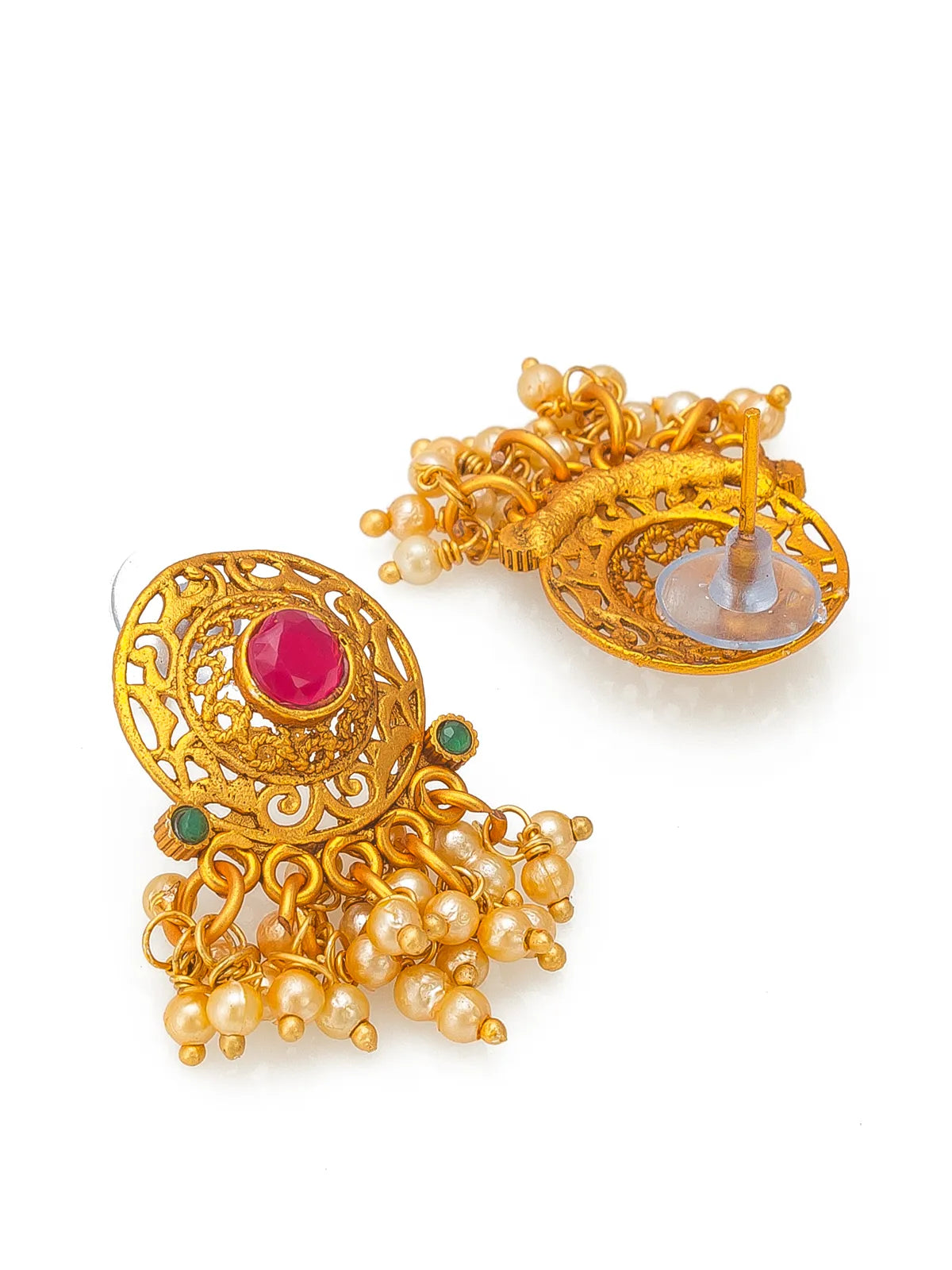 A pair of ornate gold-toned traditional earrings with a central pinkish-red oval stone, small green stones, and dangling pearl-like bead clusters, shown on a white background.
