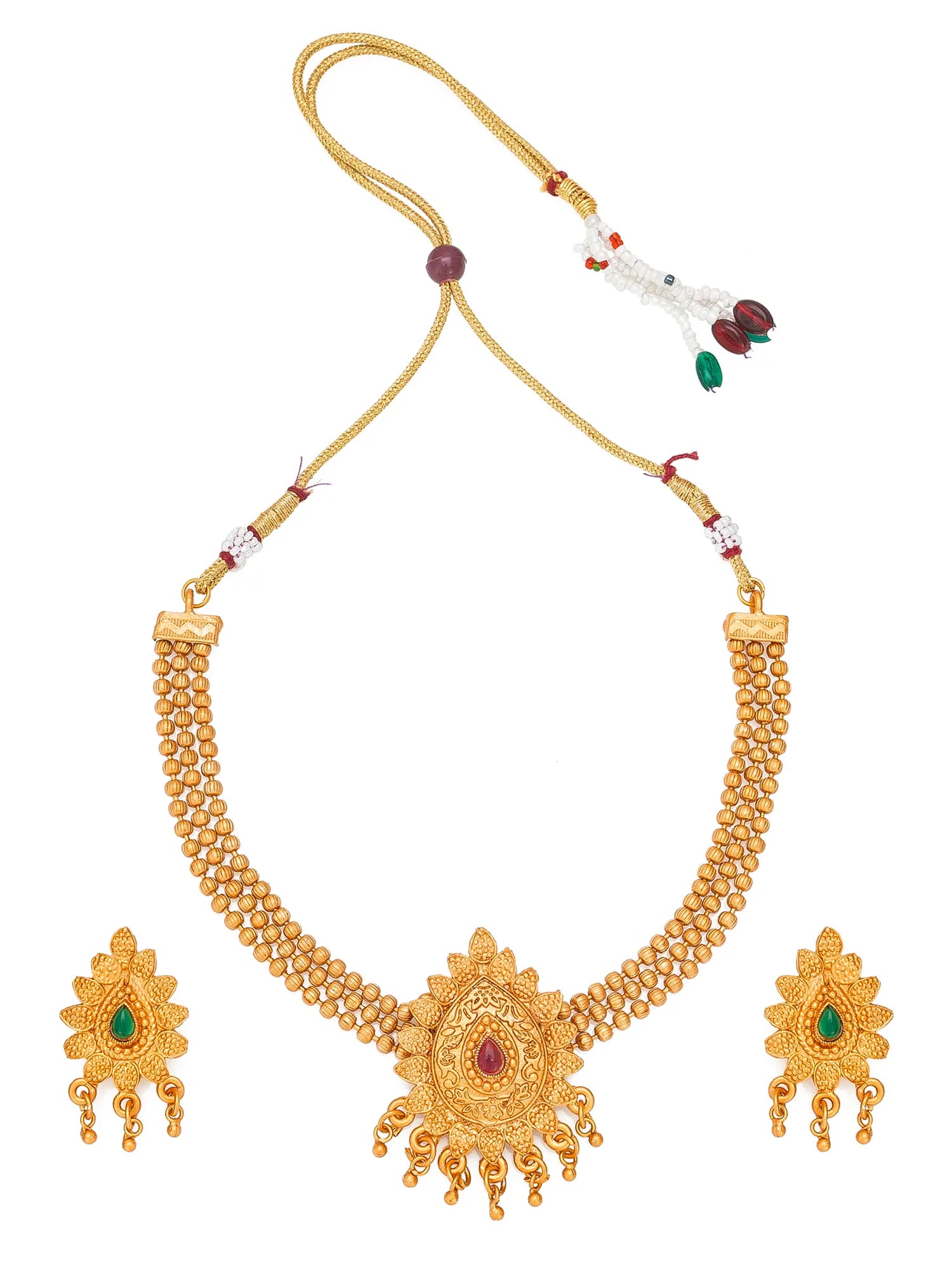 Gold-toned traditional jewelry set featuring a beaded necklace with a central sunburst pendant, a matching cord with decorative beads, and two matching dangling earrings with green and red stone accents, shown on a plain white background.
