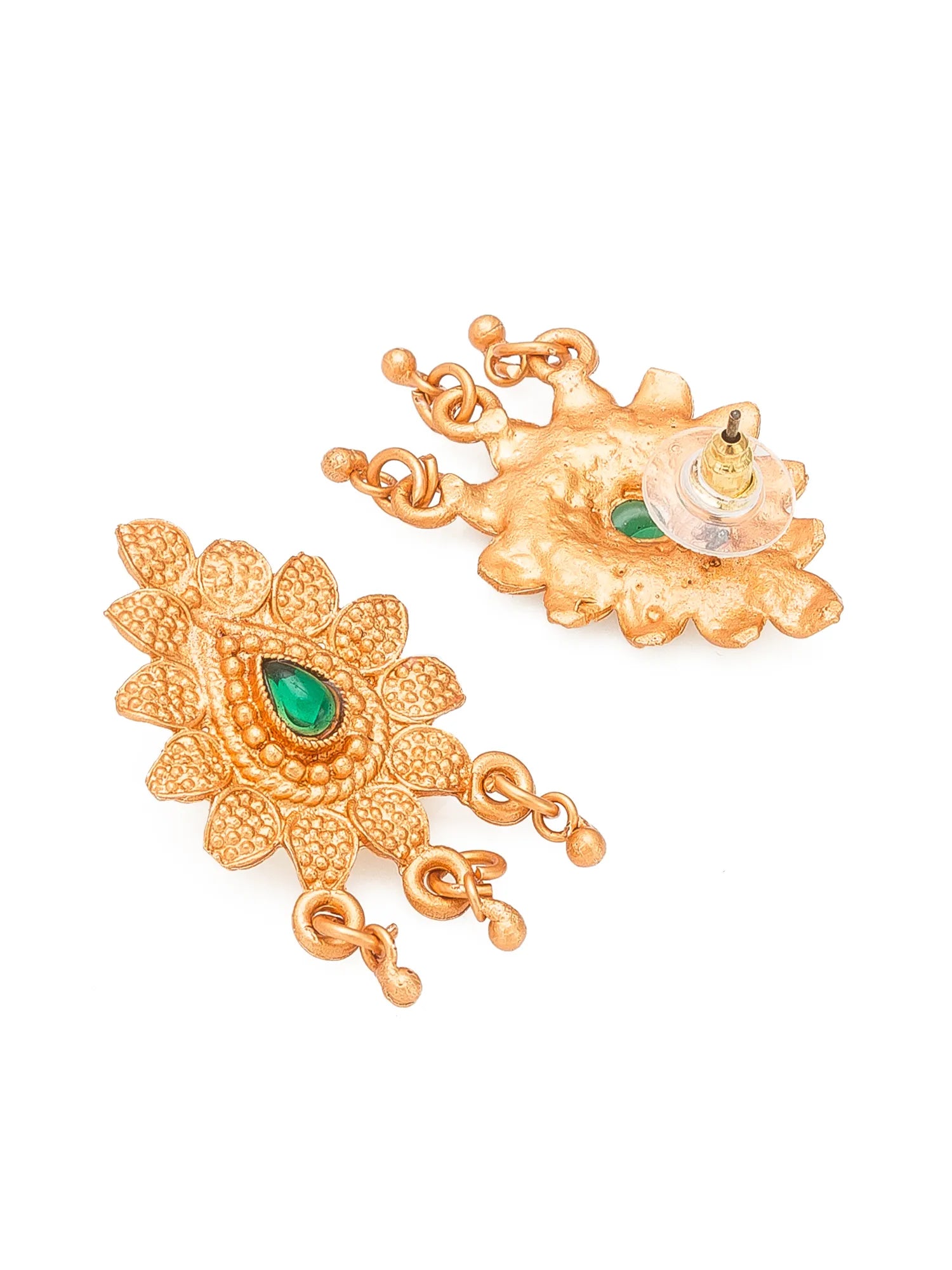 A pair of gold-toned traditional Indian earrings with detailed floral motifs and green teardrop gemstones, shown on a plain white background.