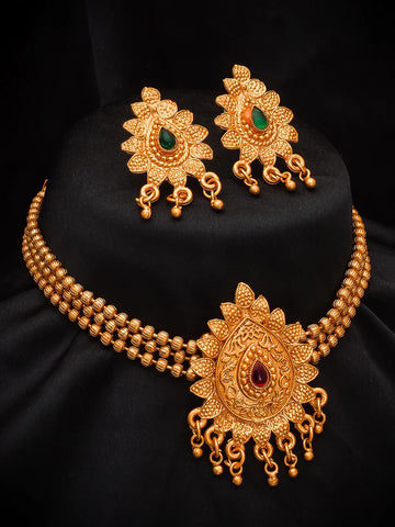 Gold-toned traditional jewelry set featuring a multi-strand necklace with an ornate pendant, matching earrings, and a black display bust.