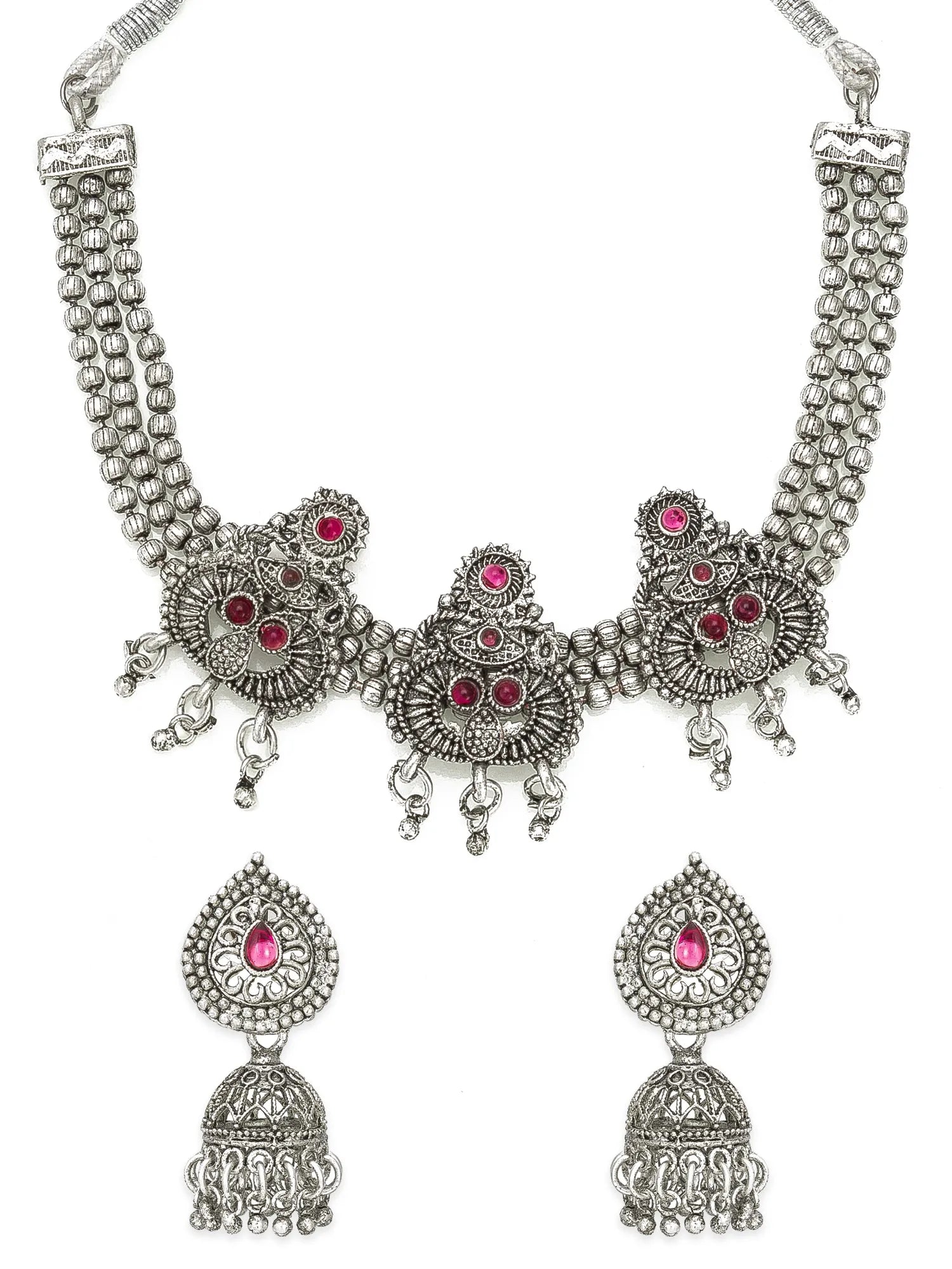 Silver-toned traditional Indian jewelry set featuring a choker necklace and matching drop earrings, embellished with intricate filigree work and small pink gemstone accents, shown on a plain white background.