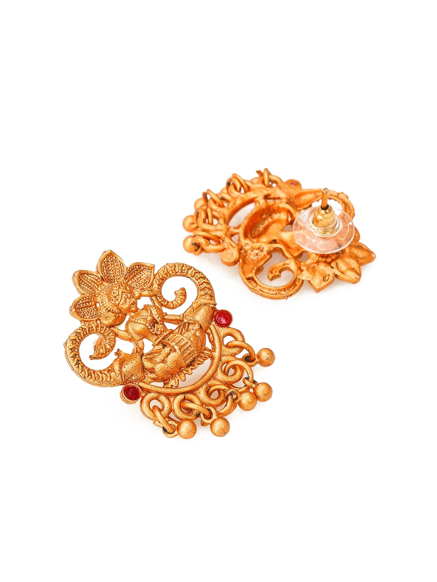 A pair of ornate gold-toned traditional Indian earrings with intricate filigree, floral motifs, and small red stone accents, displayed on a clean white background.