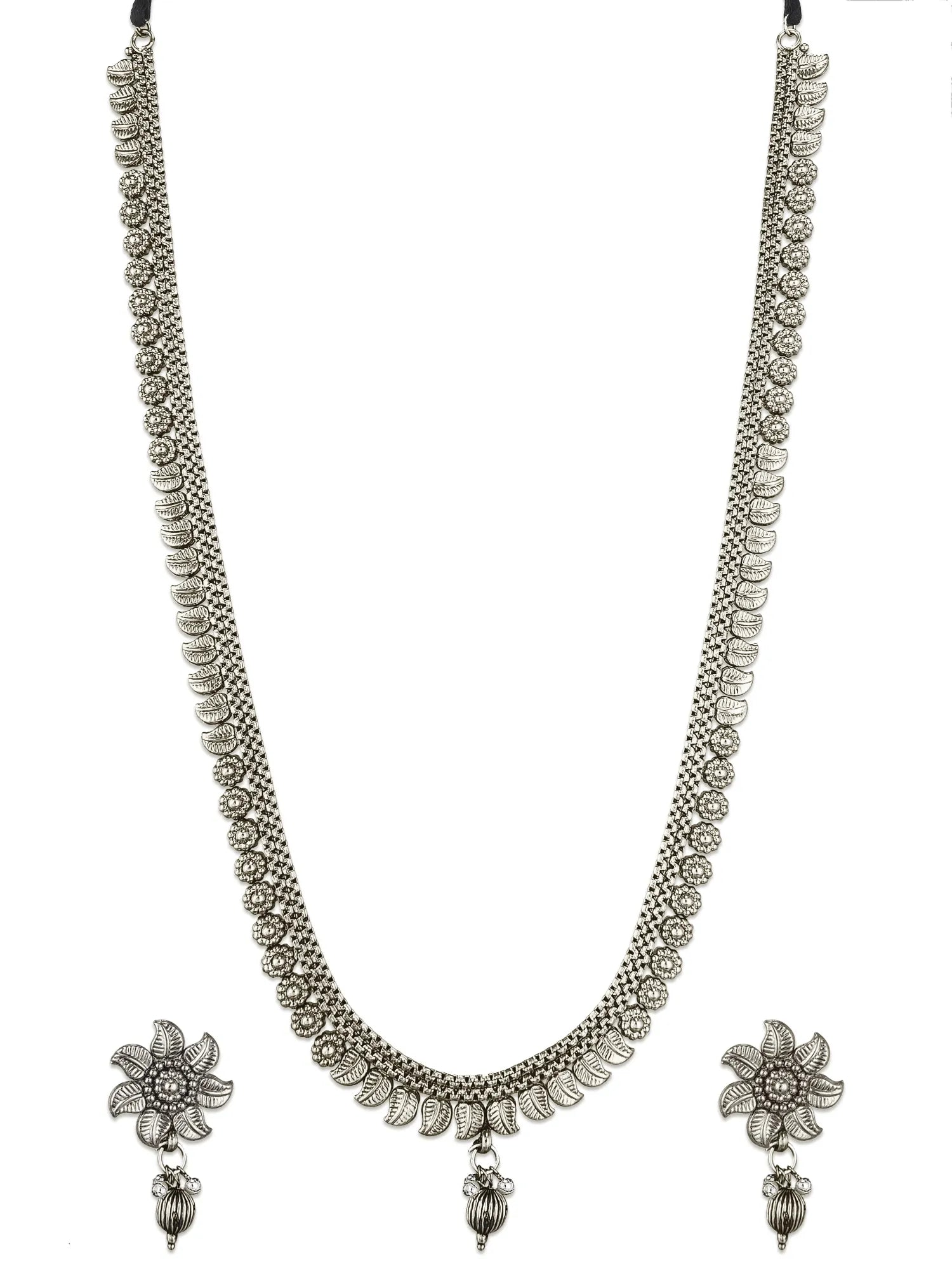 A silver-toned traditional necklace with matching flower-shaped dangle earrings, displayed on a plain white background.
