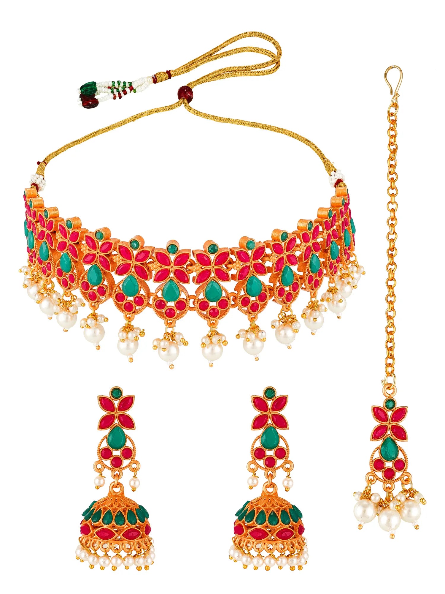 Gold-plated Indian traditional jewelry set featuring a choker necklace, matching dangling earrings, and a maang tikka, decorated with red and green enamel, white faux pearls, and gold-toned metalwork on a white background.