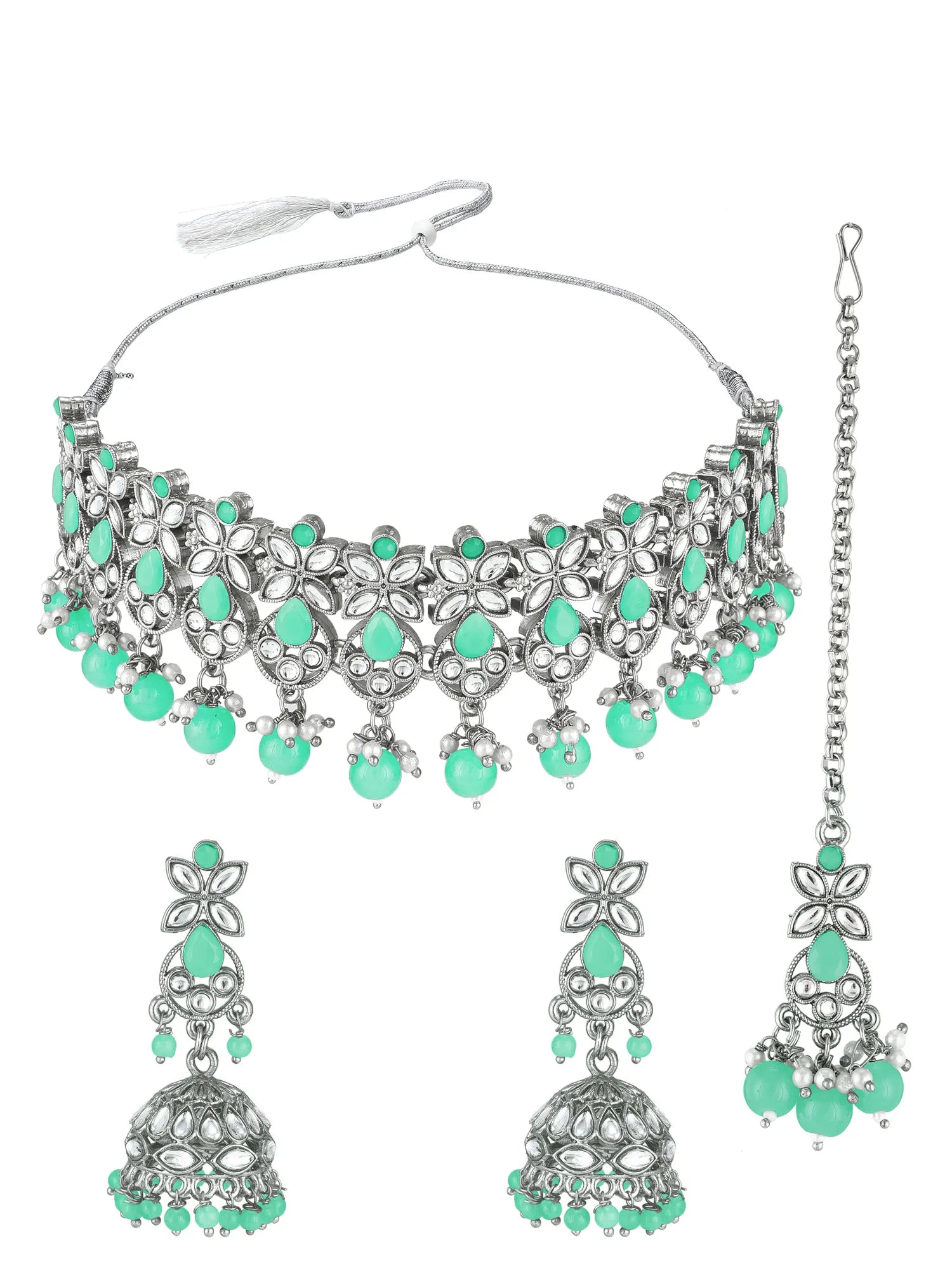 Silver-toned traditional Indian jewelry set featuring a choker necklace, matching drop earrings, and a maang tikka, embellished with mint green teardrop and round stones on a white background.