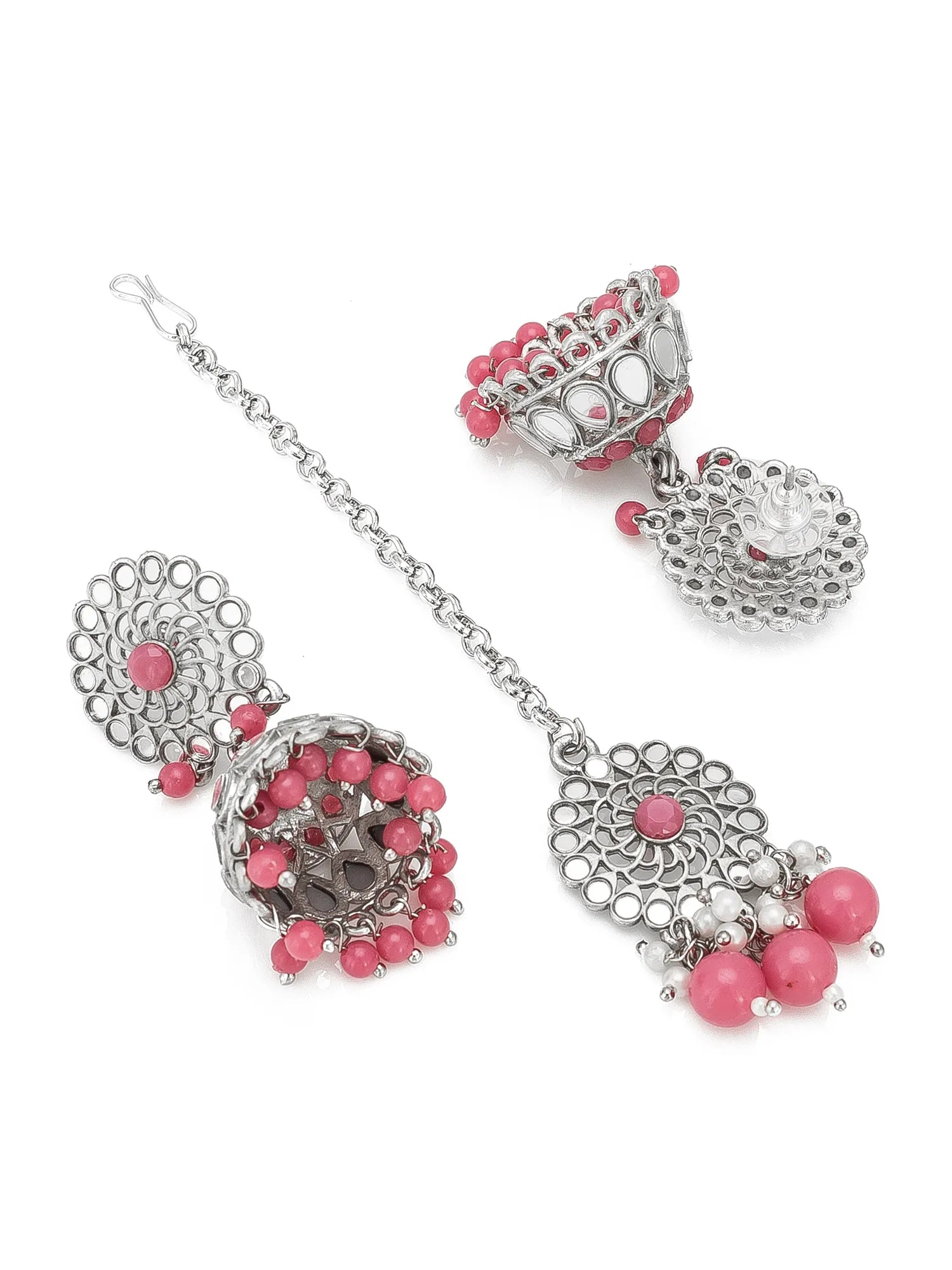 A silver-toned traditional Indian jewelry set featuring a long chain with a large jhumka, a matching top piece, and a heart-shaped pendant, embellished with pink beads and clear stones on a white background.