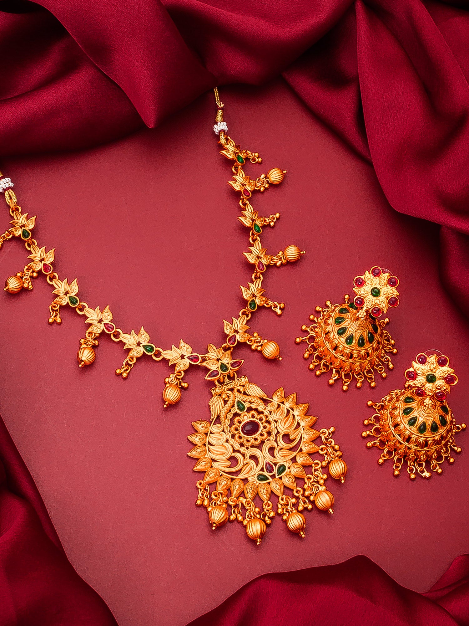 Aadita South Indian wear Gold-Toned Temple Floral Pendant Long Necklace Set with Jhumka Earrings