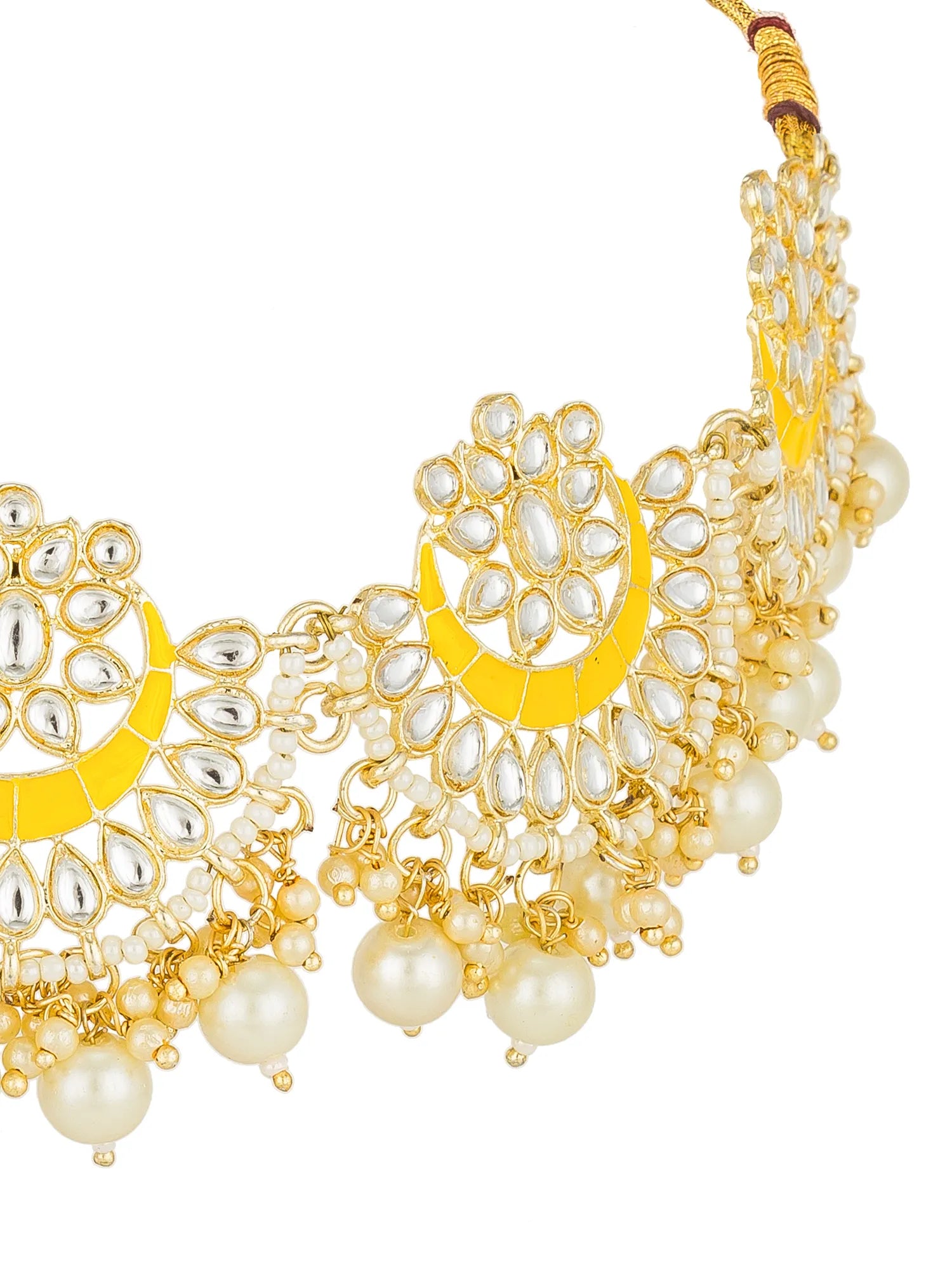 Gold-toned statement necklace with white faux pearls, silver-toned teardrop stones, and bright yellow crescent-shaped enamel details on a white background.