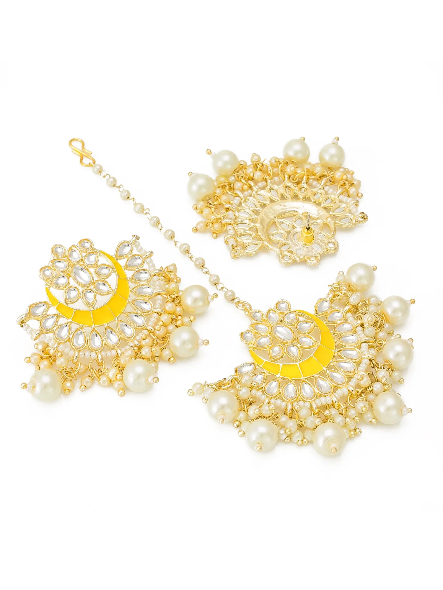 Gold and white pearl jewelry set featuring a large maang tikka, matching earrings, and a chain, displayed on a clean white background.