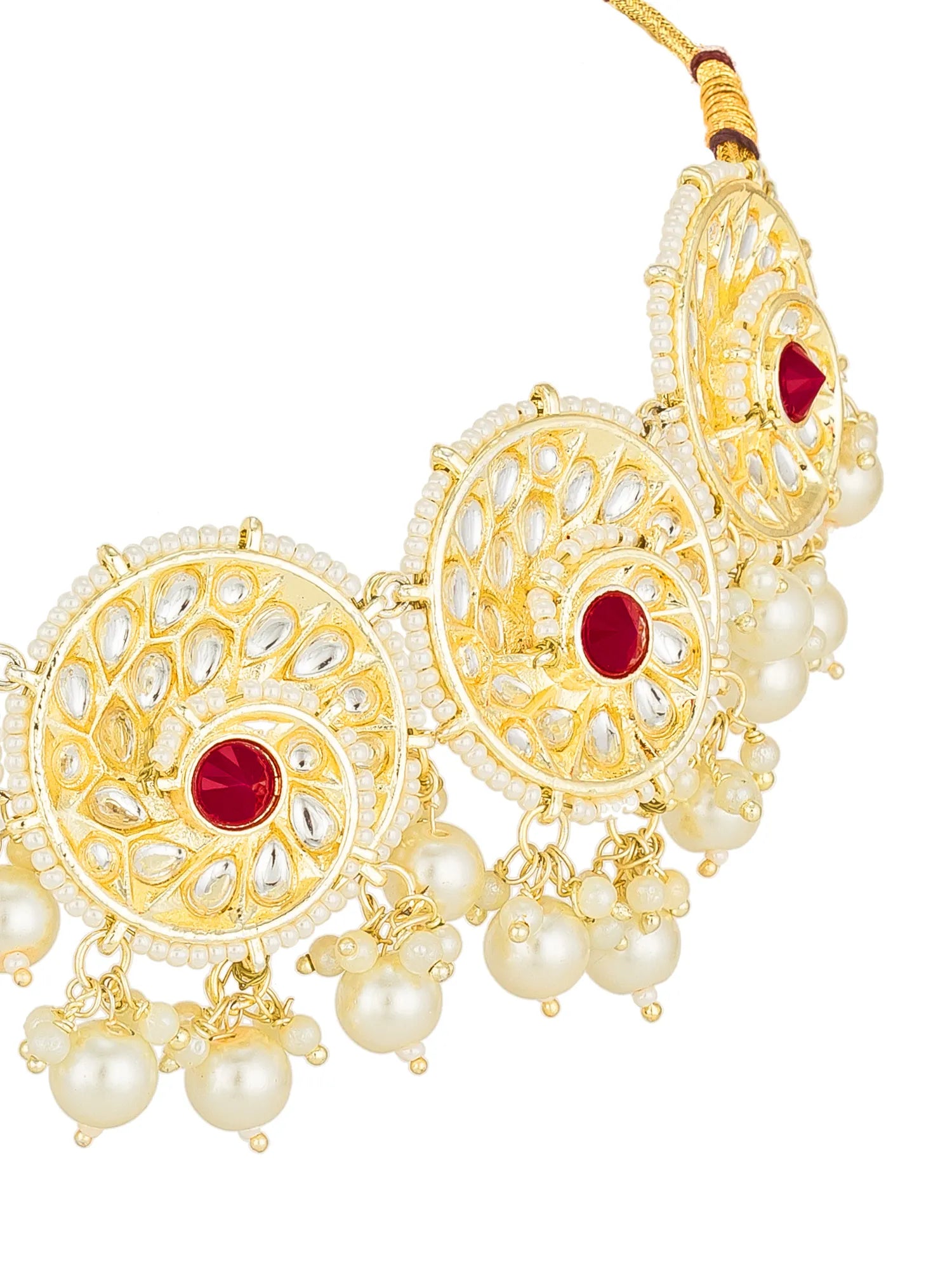 Gold-toned statement statement collar necklace with intricate filigree work, white pearl beads, and red gemstone accents, shown on a plain white background.