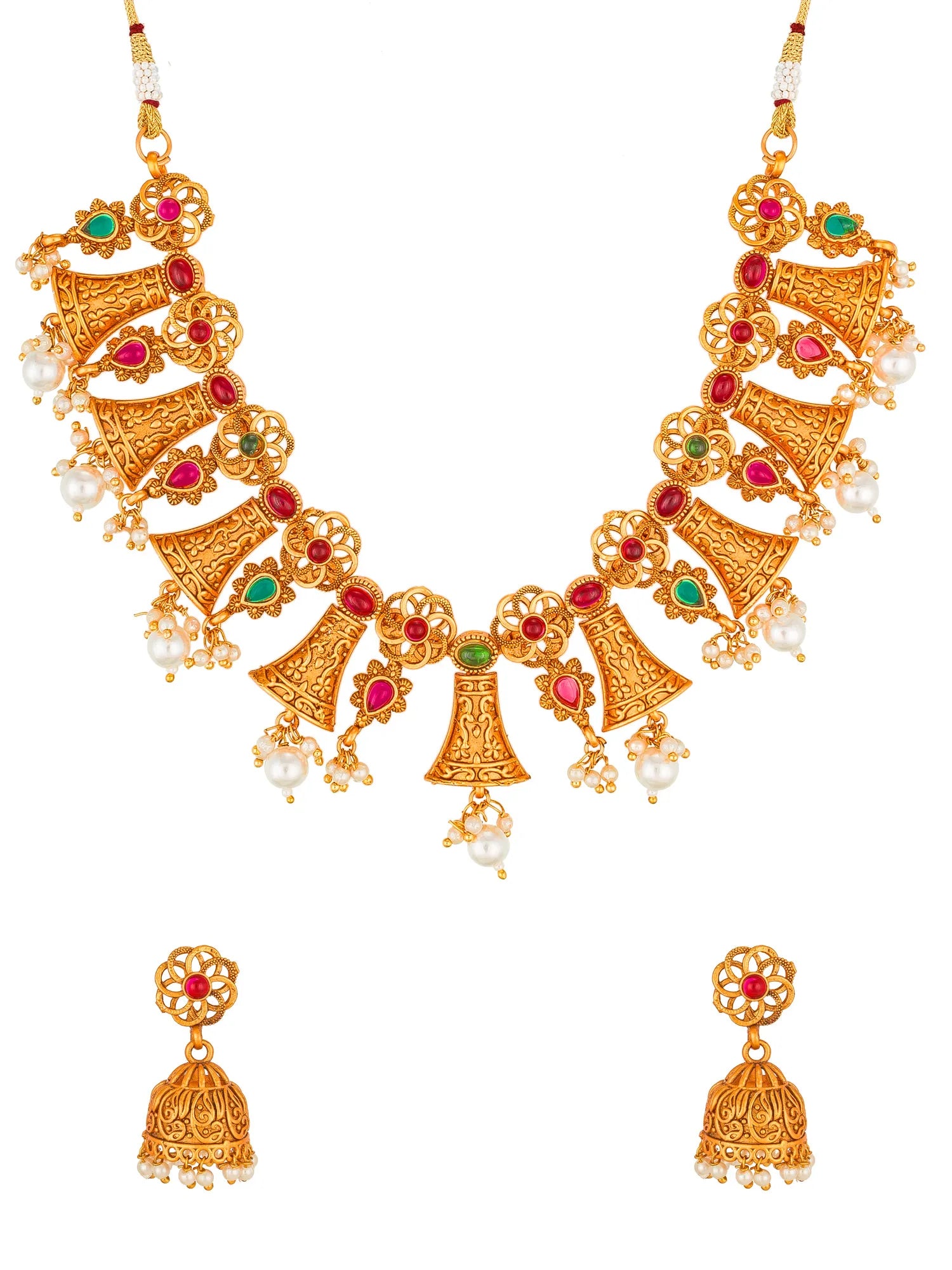 Gold-plated traditional Indian jewelry set featuring a statement necklace and matching jhumka earrings, embellished with red and green stones and white faux pearls, shown on a plain white background.