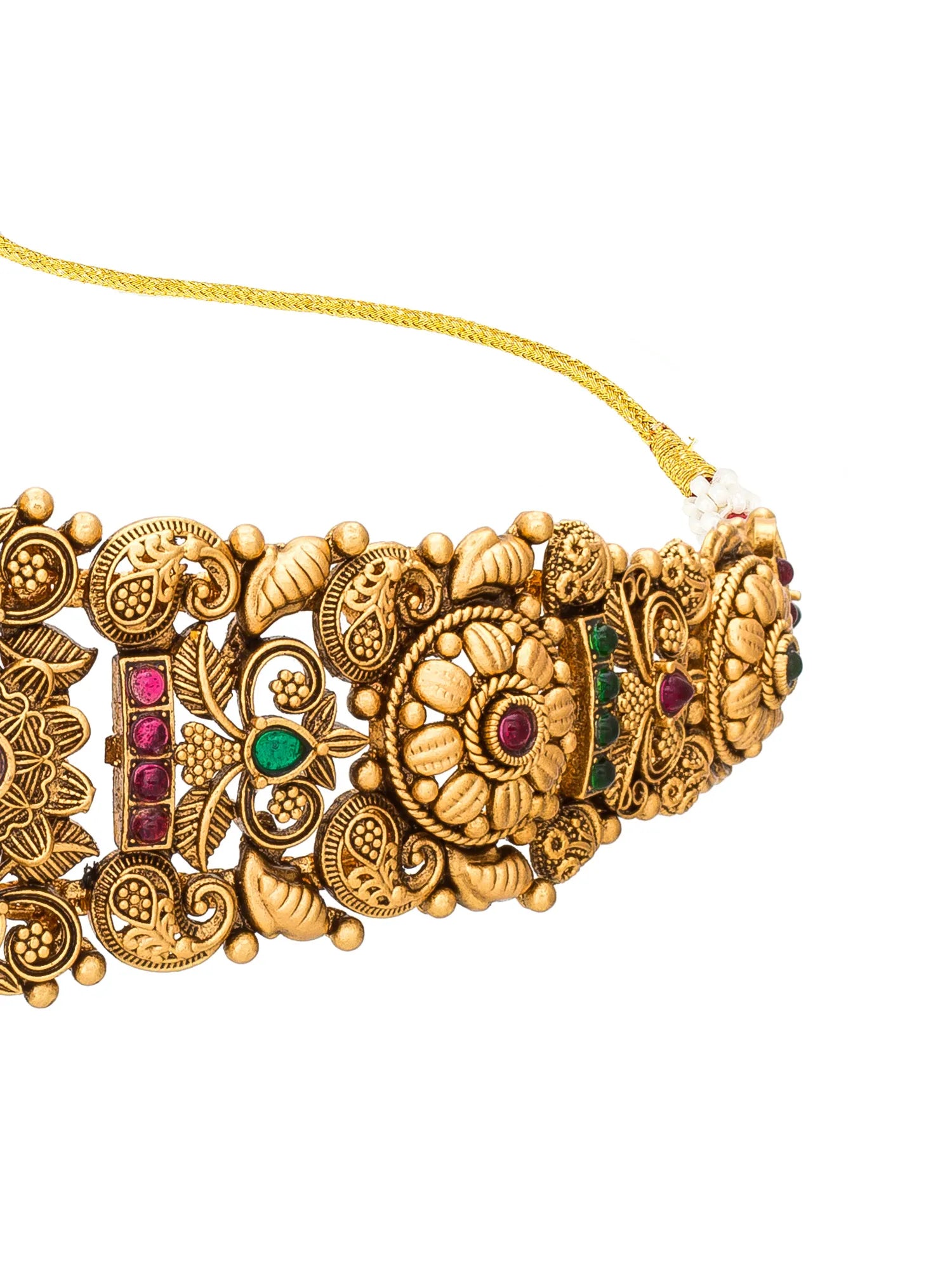 An ornate gold-toned traditional necklace with intricate filigree patterns and small green and pink gemstone accents, shown against a plain white background.