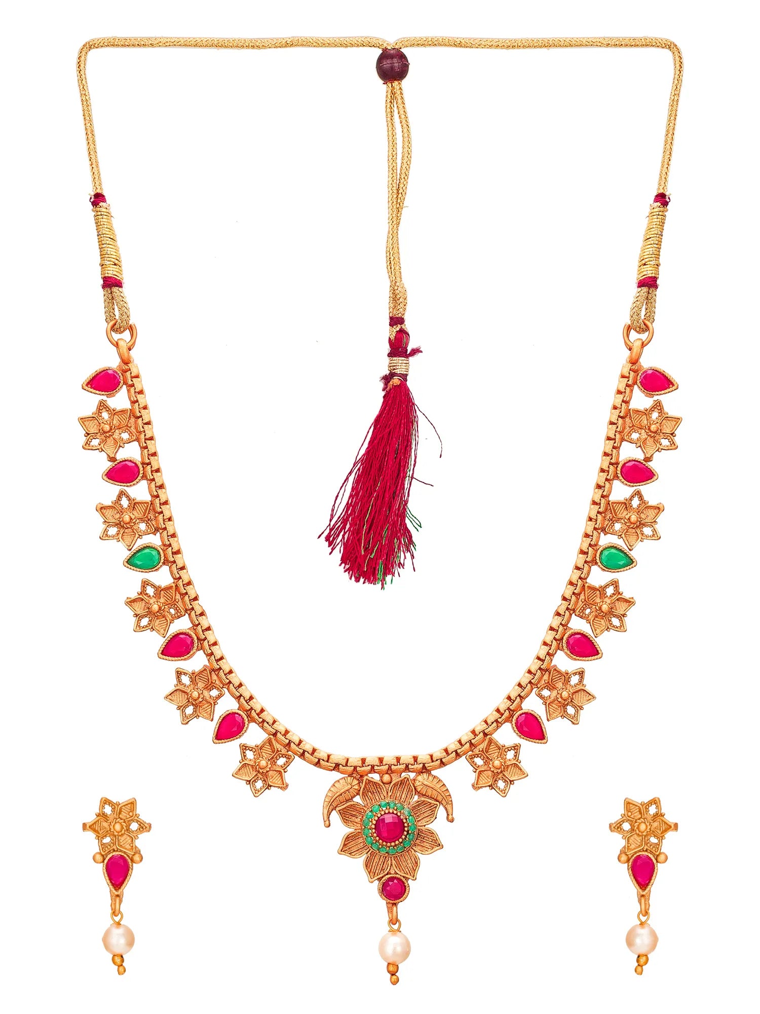 Gold-plated Indian style necklace and matching earrings set with red and green stones and white pearls on a white background.