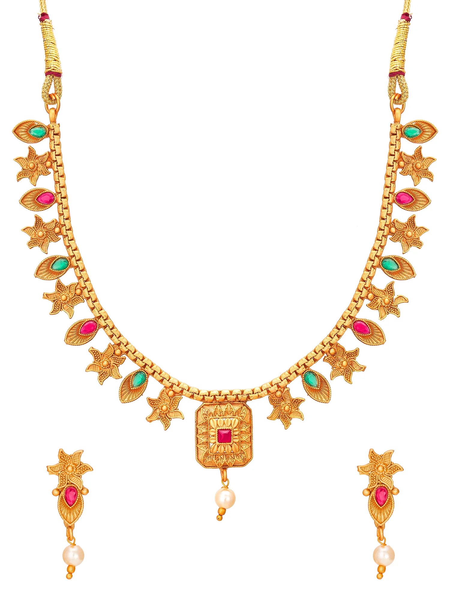 Gold-plated traditional Indian jewelry set featuring a necklace and matching earrings, embellished with red gemstones, green stones, and white pearl drops on a plain white background.