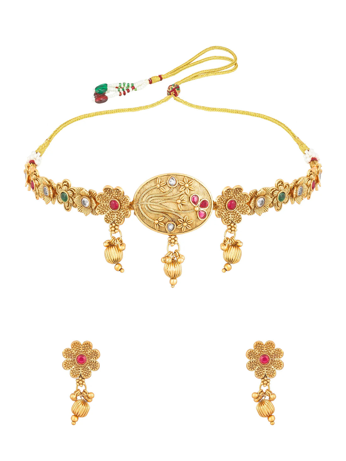 Gold-toned traditional Indian jewelry set featuring a necklace and matching earrings, embellished with red, green, and white stones on a teal background.
