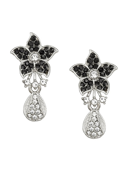 Pair of floral earrings with black gemstones and silver accents on a white background