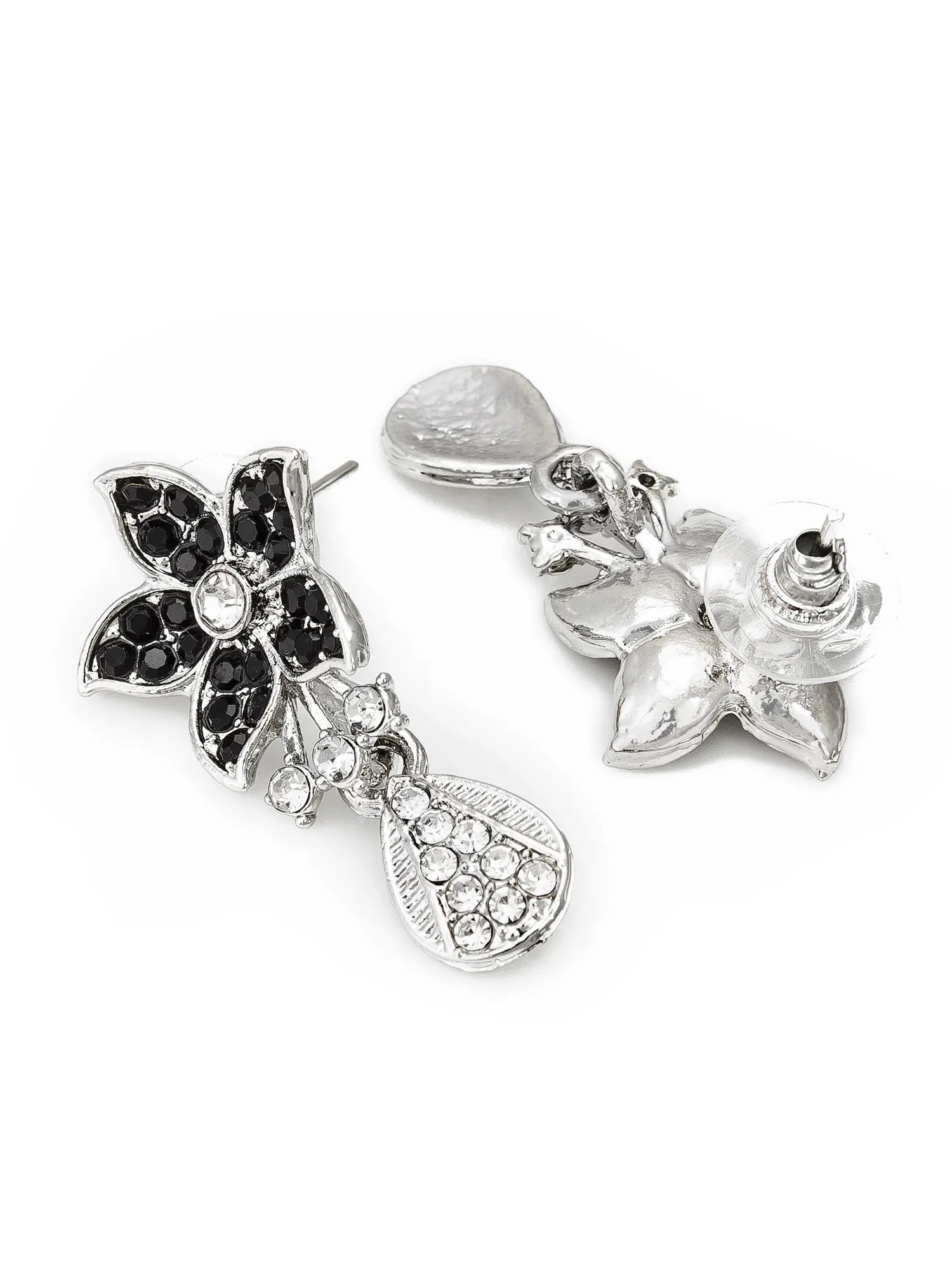 Pair of silver earrings with floral and heart designs on a white background