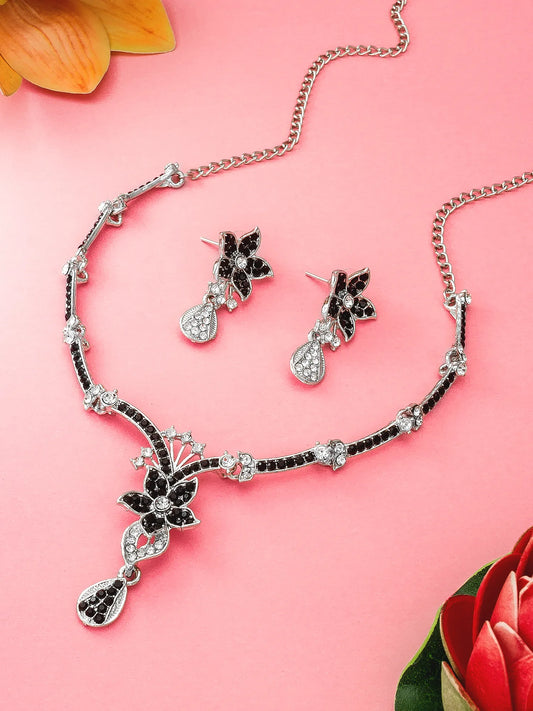 Jewelry set with necklace and earrings on a pink background