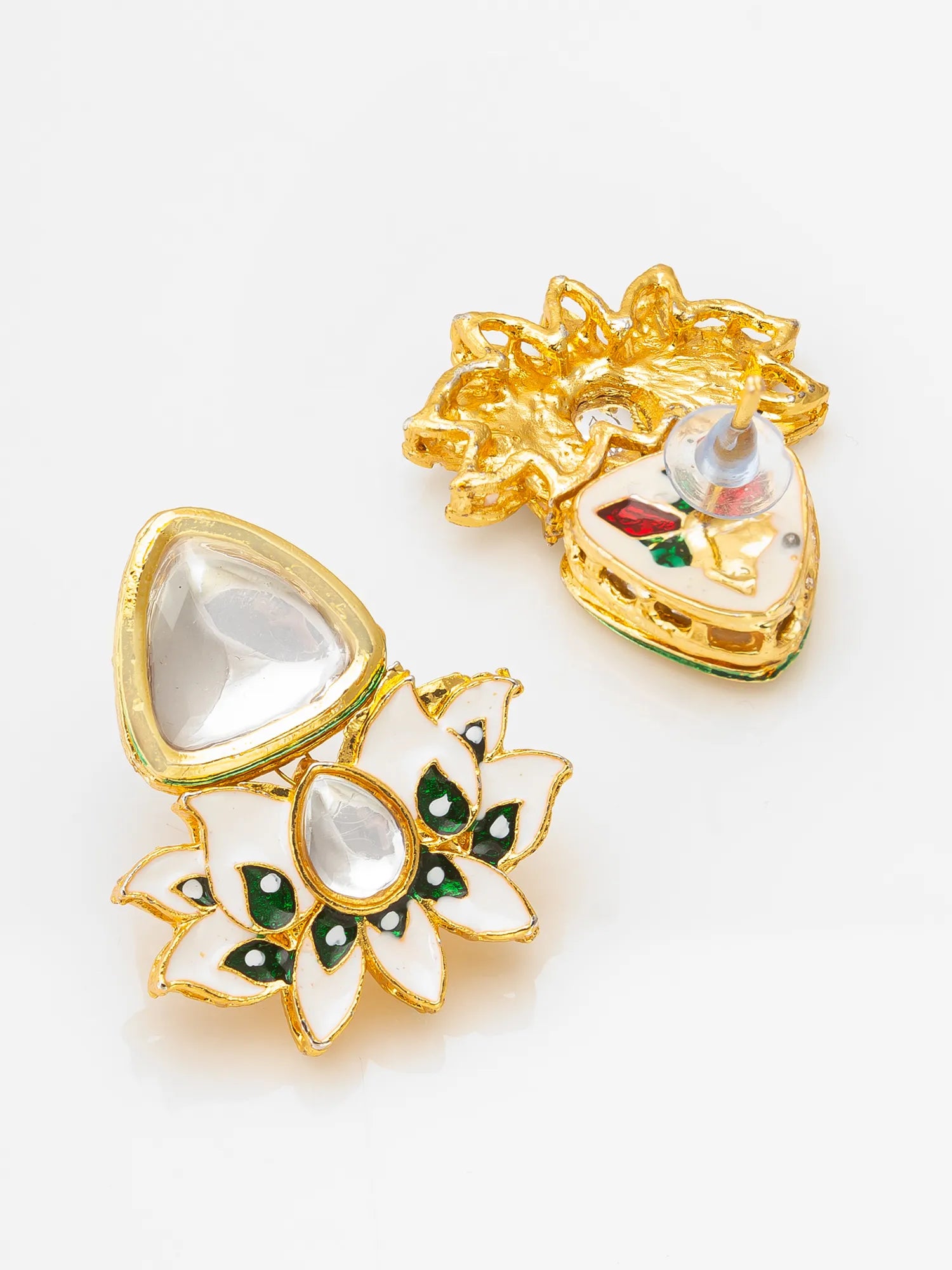 A pair of gold-plated Kundan earrings with white stone inlays and green enamel accents, displayed on a clean white background.
