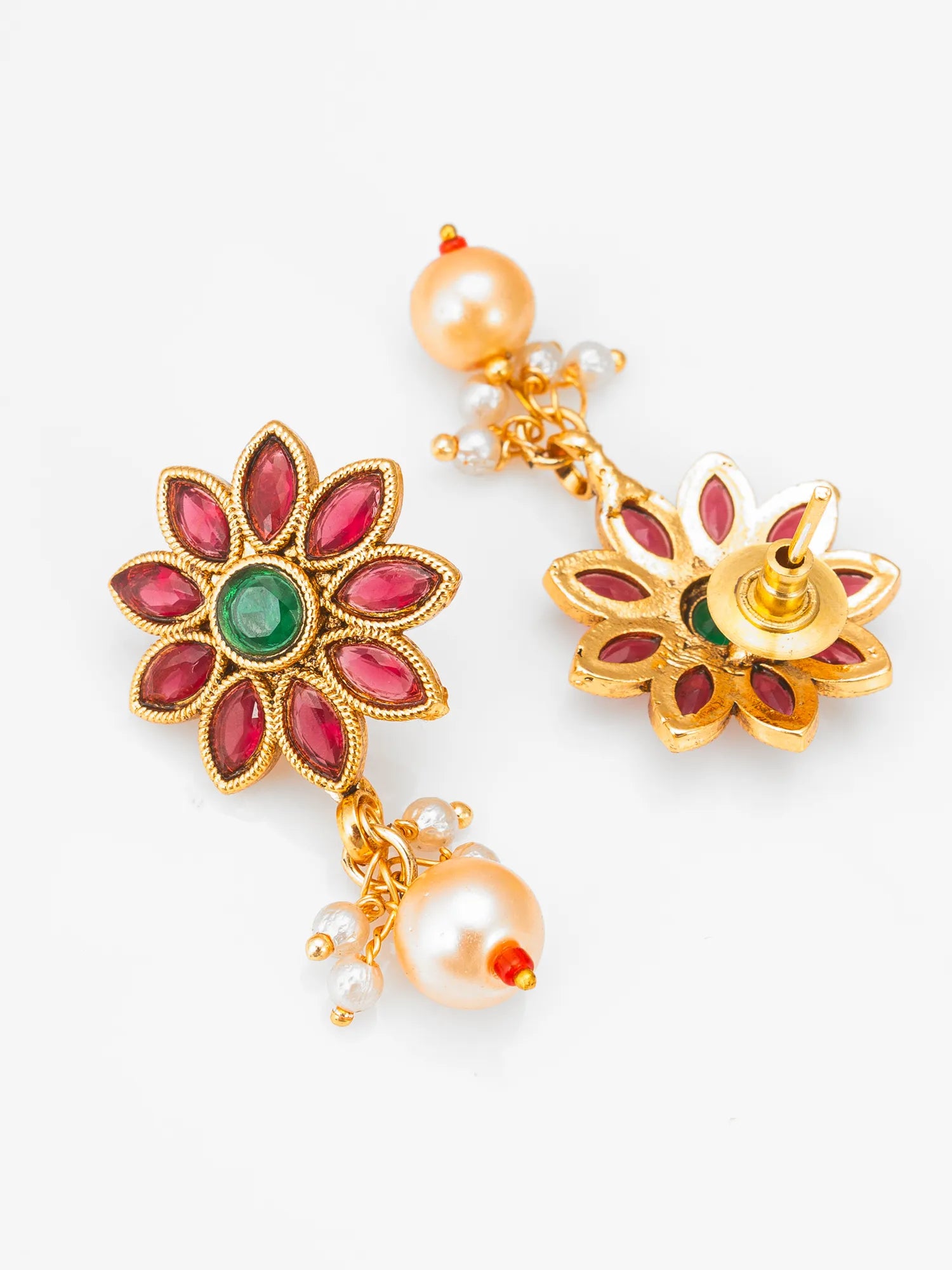 Decorative earrings with floral design and pearl accents on a white background
