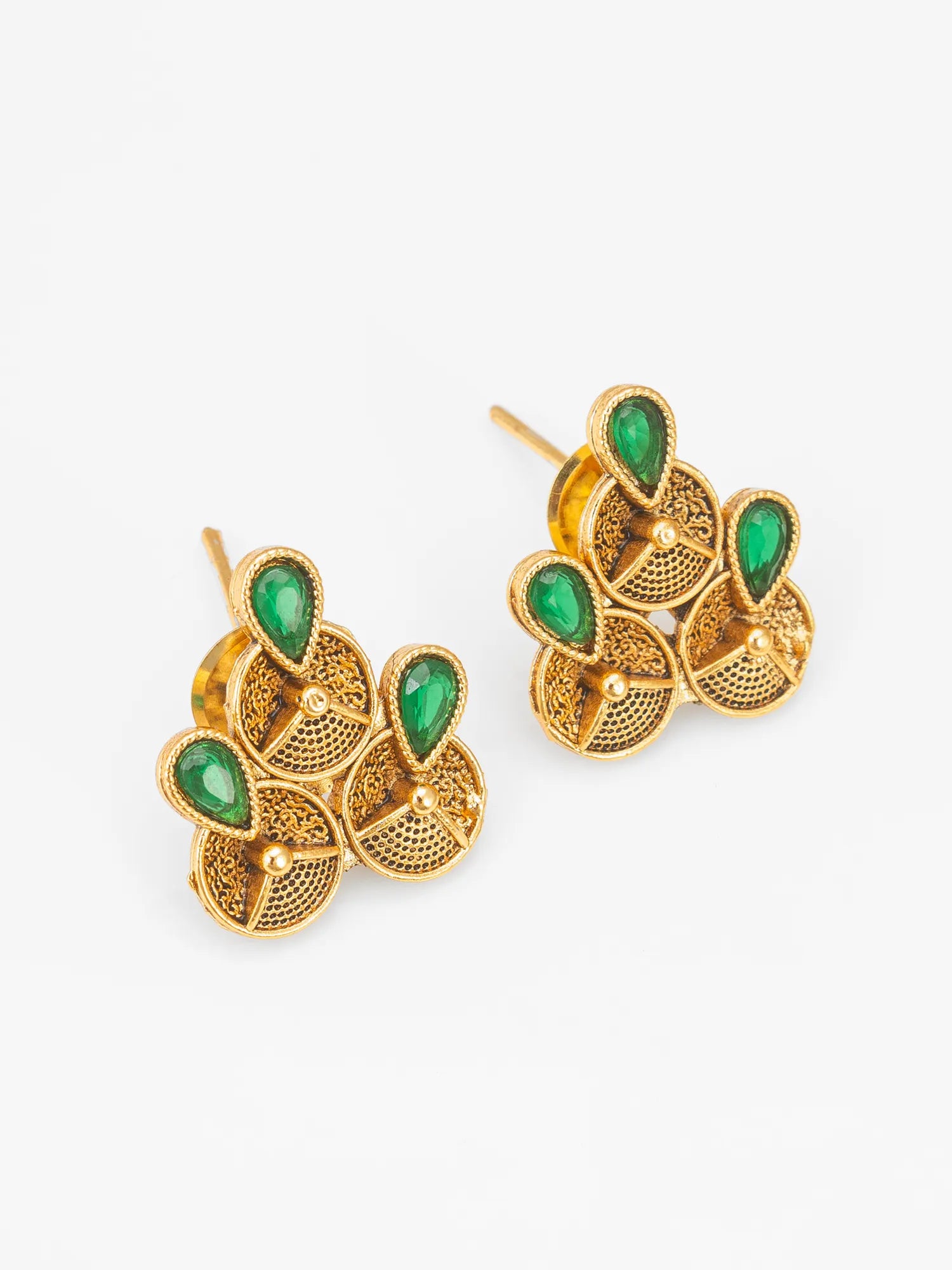 A pair of gold-toned statement earrings with green teardrop-shaped stones and textured filigree details, displayed on a clean white background.