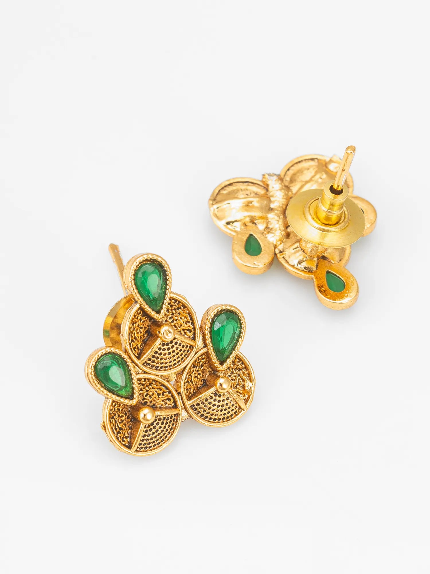 A pair of gold-toned filigree stud earrings with green teardrop-shaped stone accents, shown on a clean white background with one earring facing forward and the other angled to show the back post.