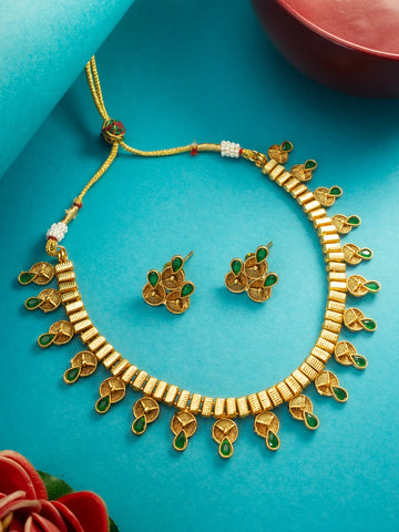 Gold necklace and earrings set on a blue background